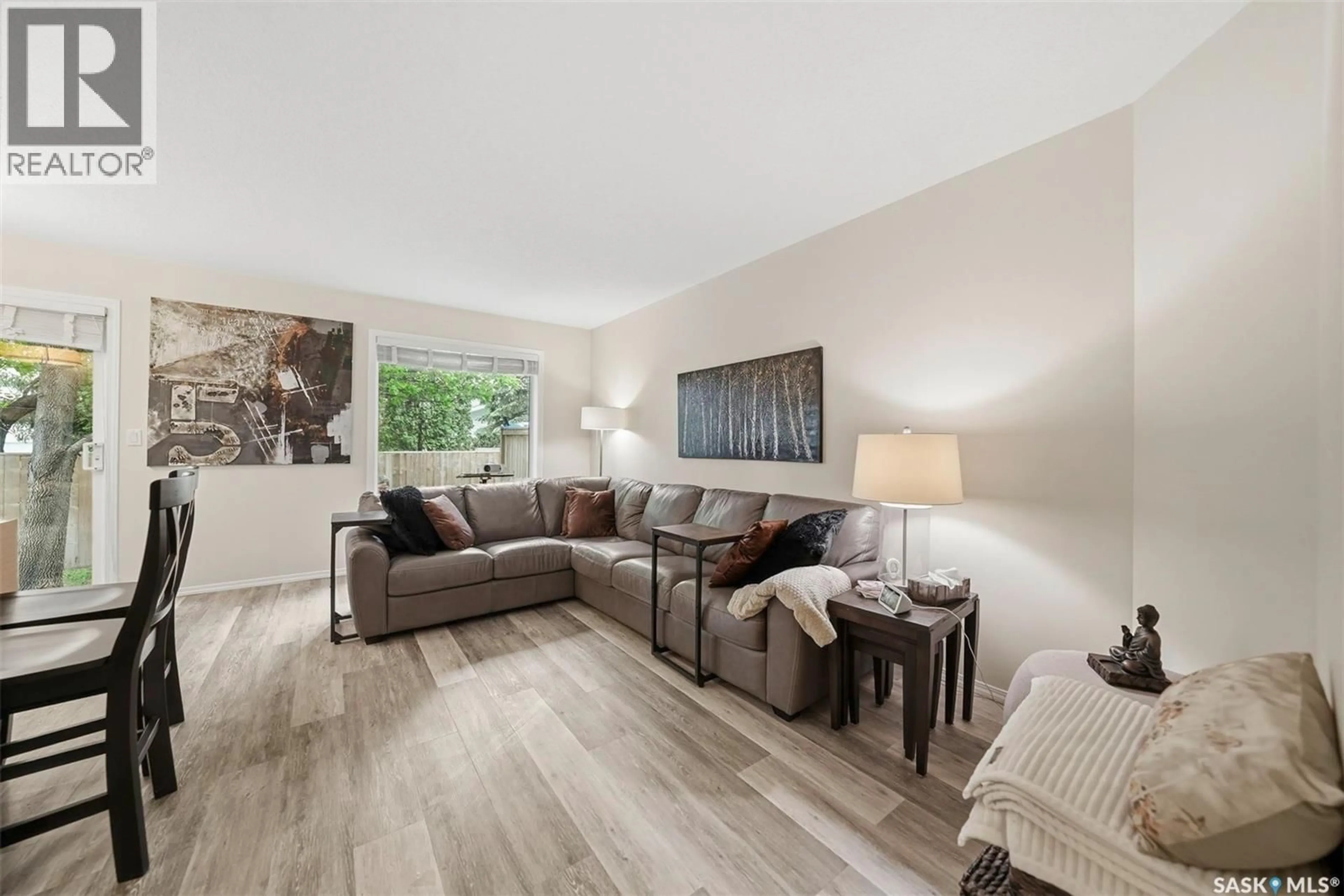 Living room with furniture, wood/laminate floor for 12 103 BERINI DRIVE, Saskatoon Saskatchewan S7N4N2