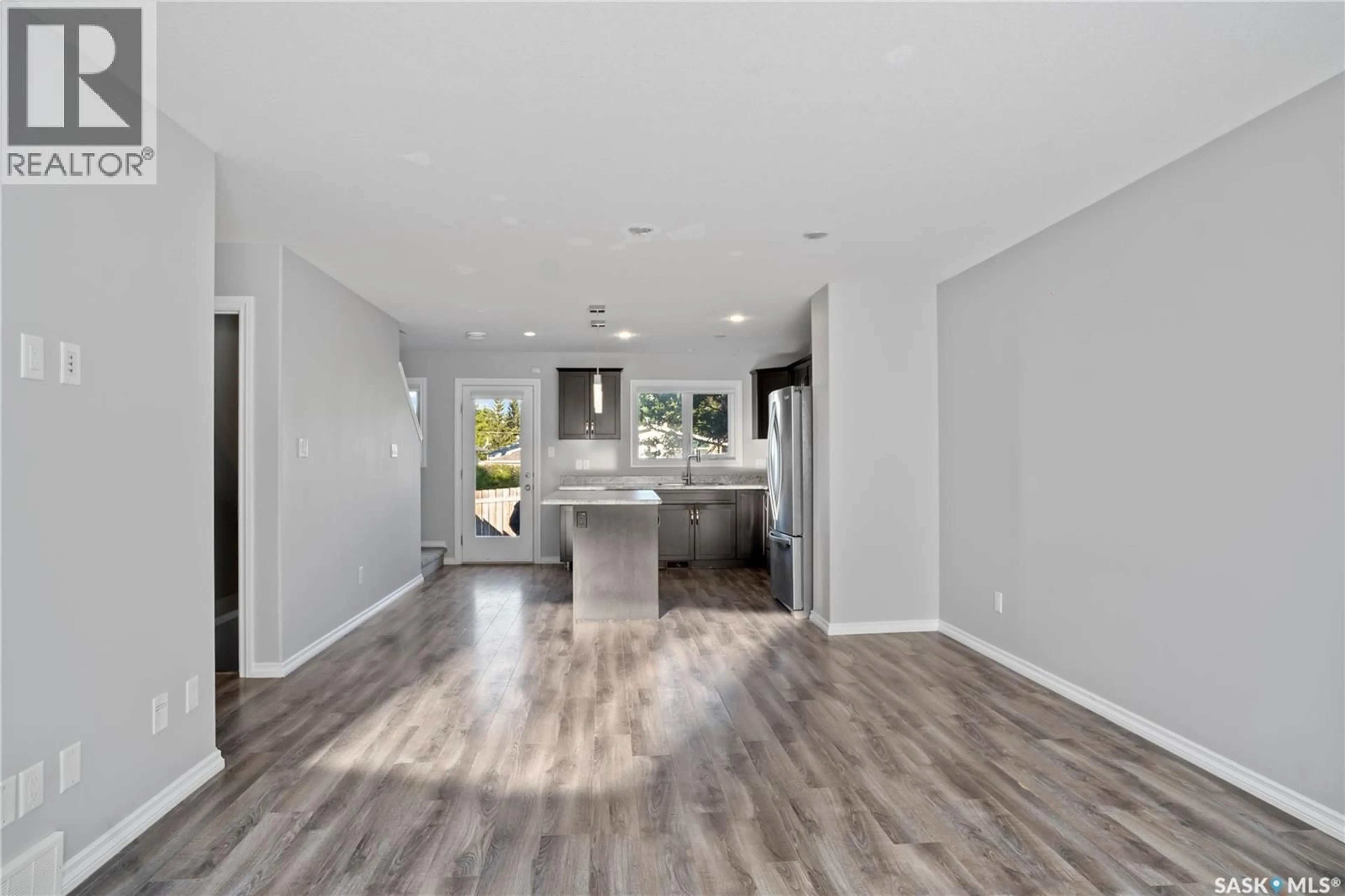 Open concept kitchen, wood/laminate floor for 110 - 4102 3RD AVENUE, Regina Saskatchewan S4R2B7