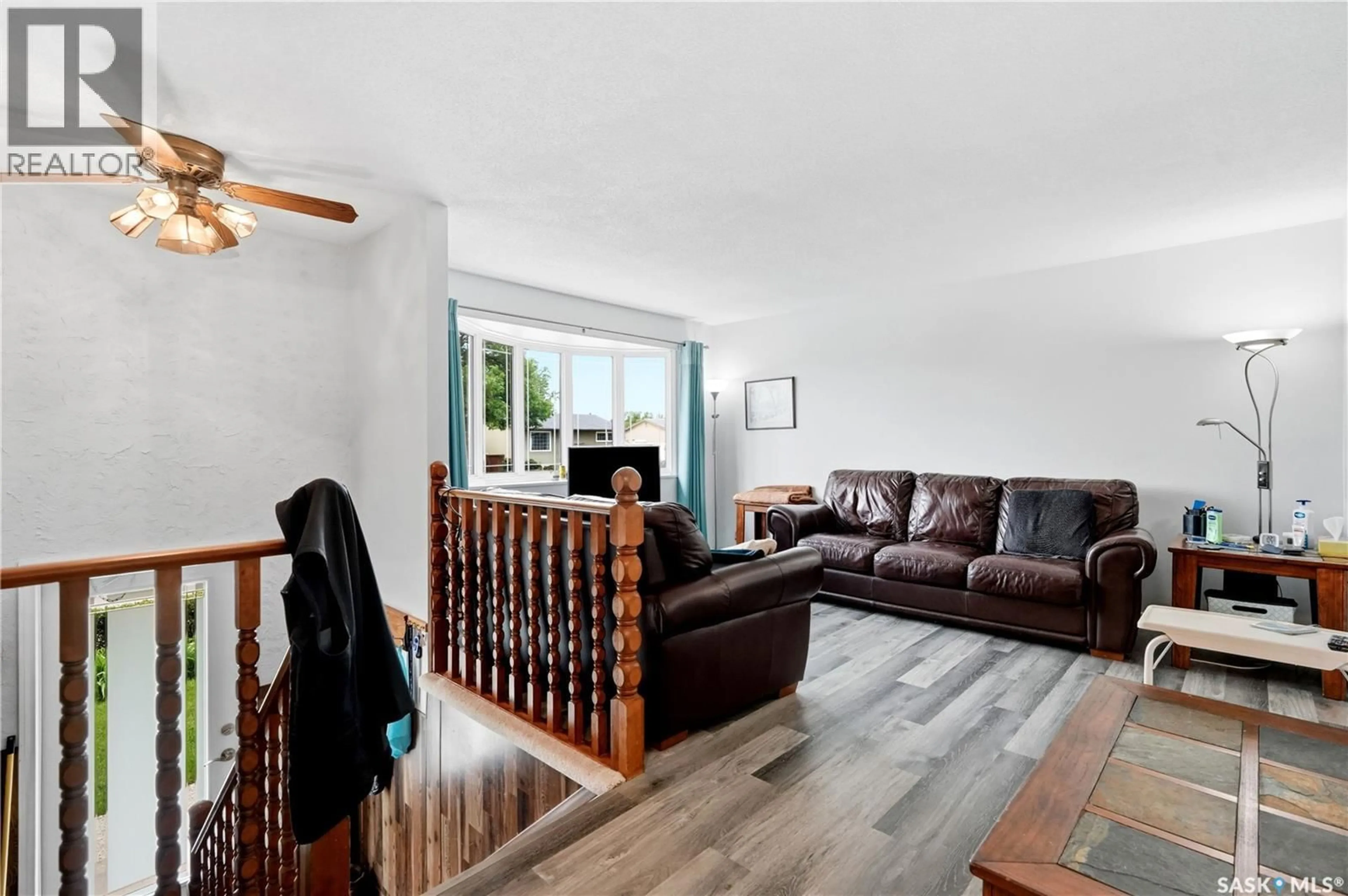 Living room with furniture, wood/laminate floor for 1223 WARNER STREET, Moose Jaw Saskatchewan S6H6G9