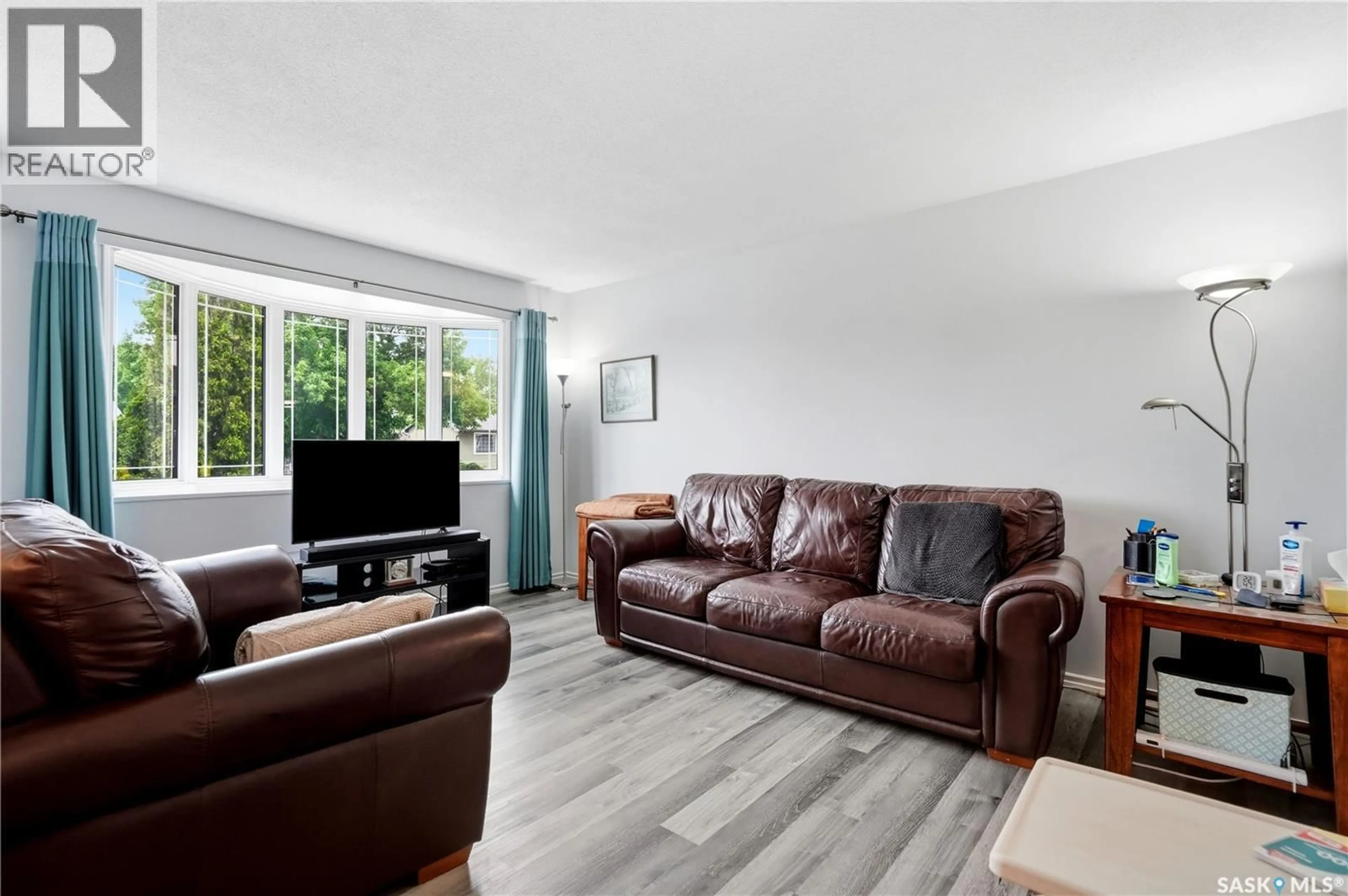 Living room with furniture, wood/laminate floor for 1223 WARNER STREET, Moose Jaw Saskatchewan S6H6G9