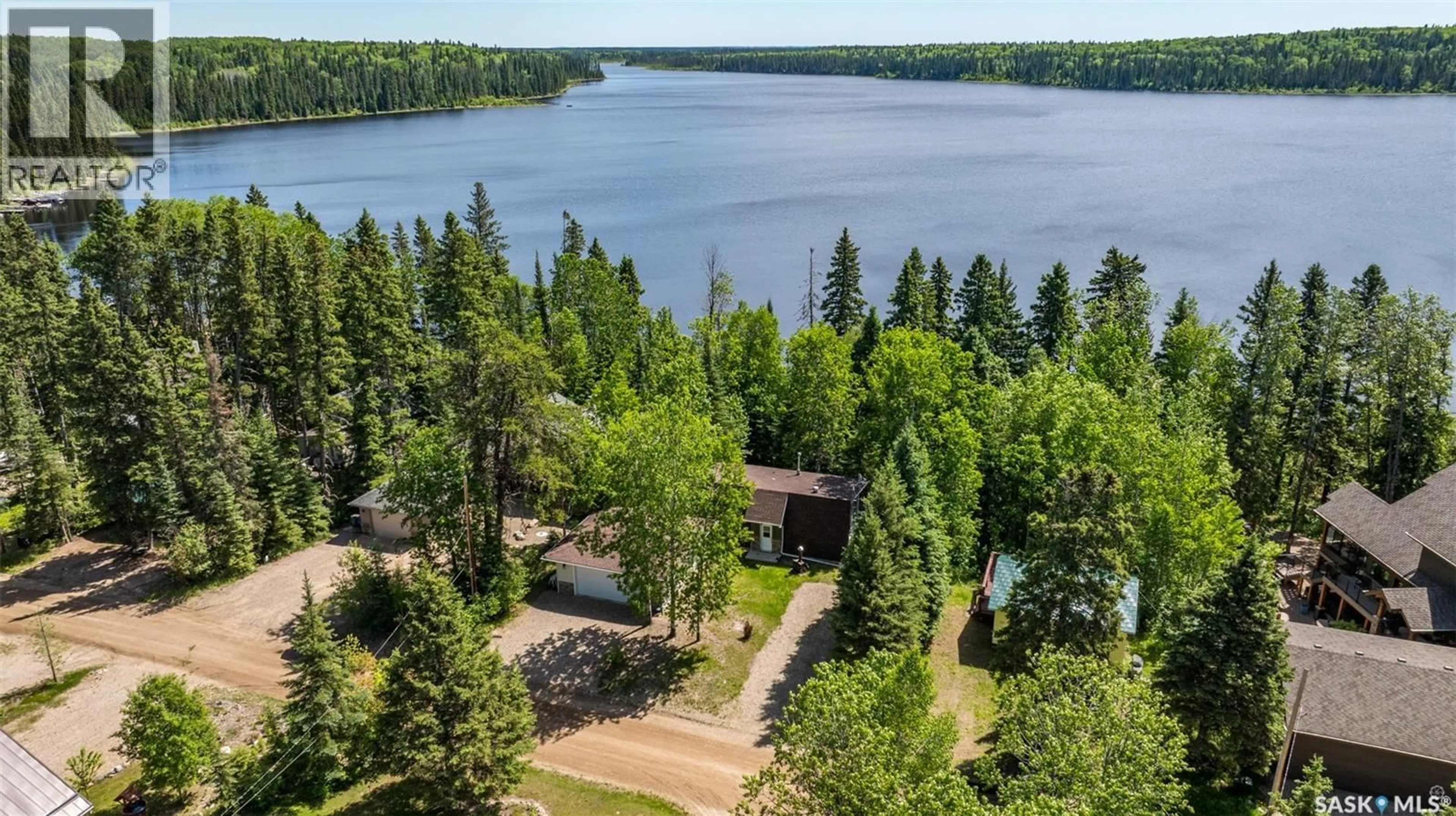 A pic from outside/outdoor area/front of a property/back of a property/a pic from drone, water/lake/river/ocean view for 109 BEAVER PLACE, McPhee Lake Saskatchewan S0J2Y0