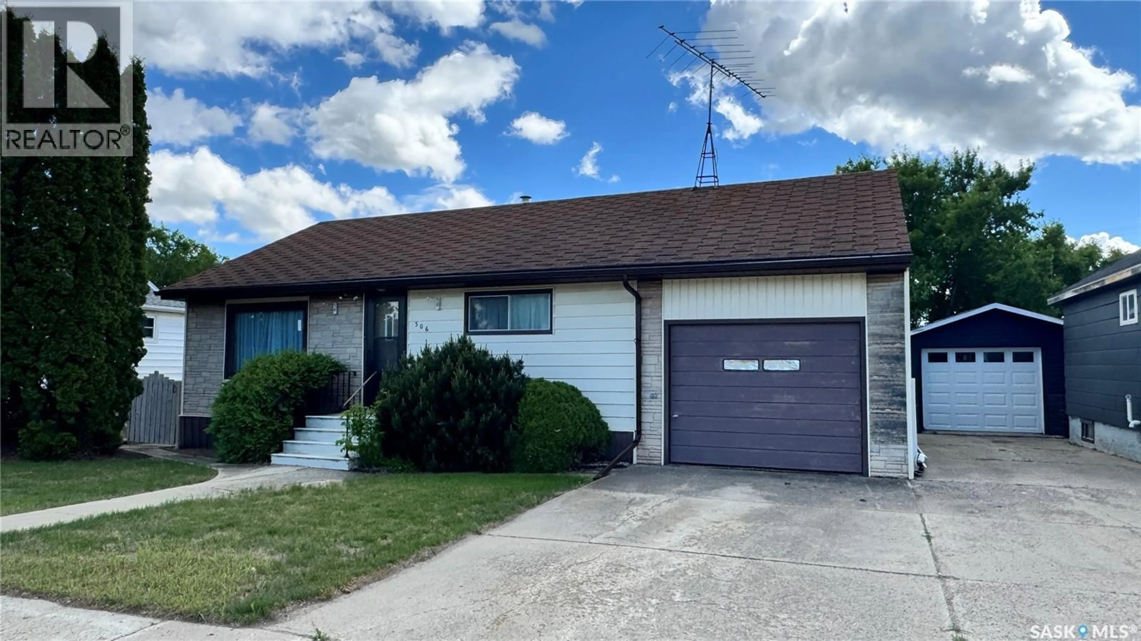 Home with vinyl exterior material, street for 306 6TH AVENUE, Biggar Saskatchewan S0K0M0