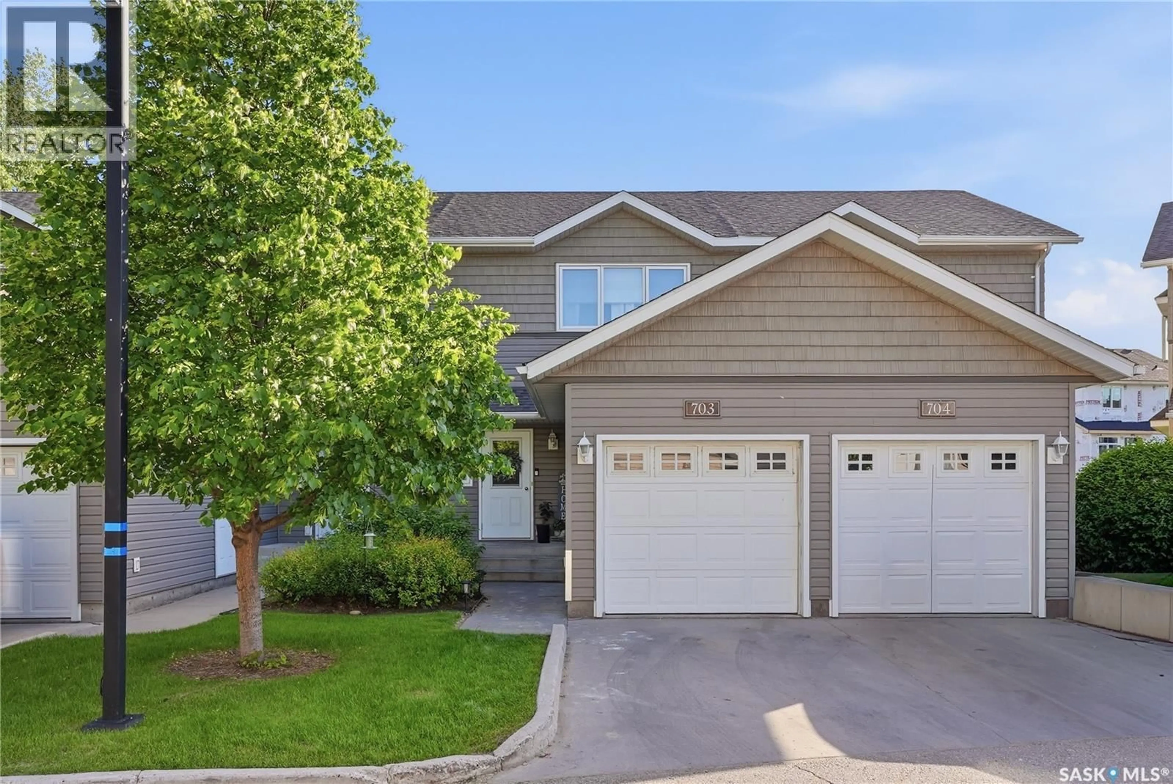 Home with vinyl exterior material, street for 703 715 HART ROAD, Saskatoon Saskatchewan S7M3Y8