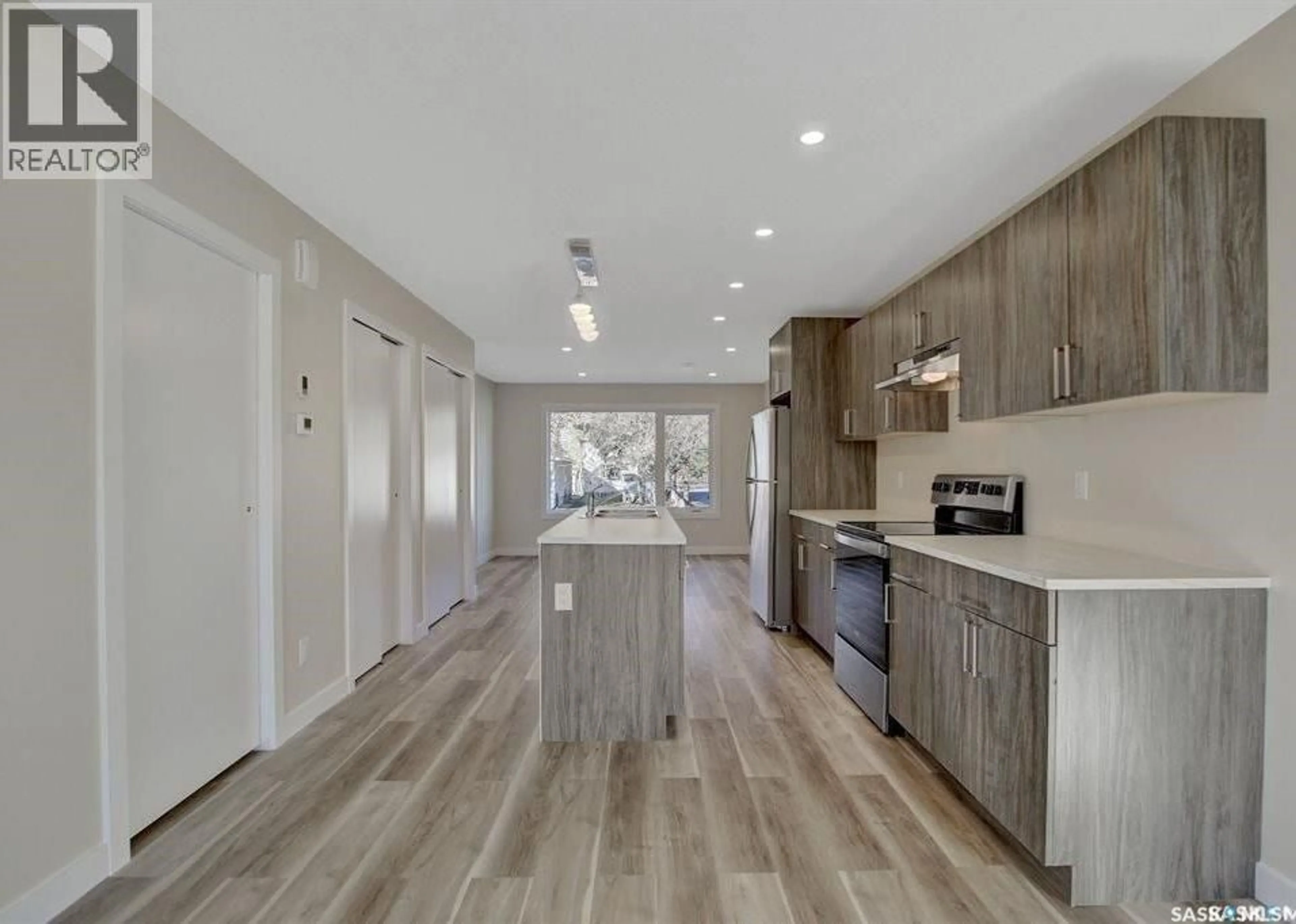 Open concept kitchen, wood/laminate floor for 2423 REYNOLDS STREET, Regina Saskatchewan S4N3N8