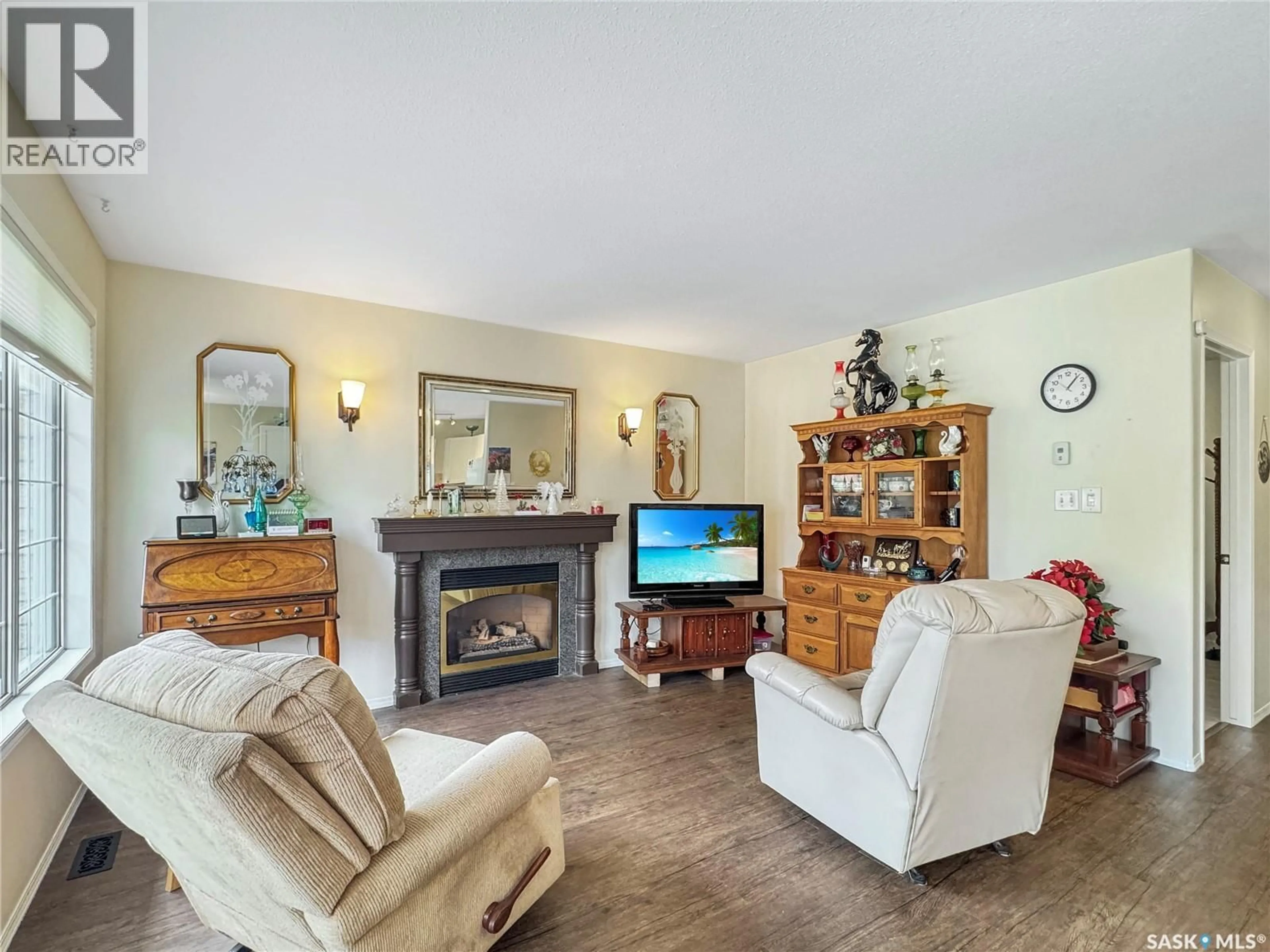 Living room with furniture, wood/laminate floor for 1091 110TH STREET, North Battleford Saskatchewan S9A2H3
