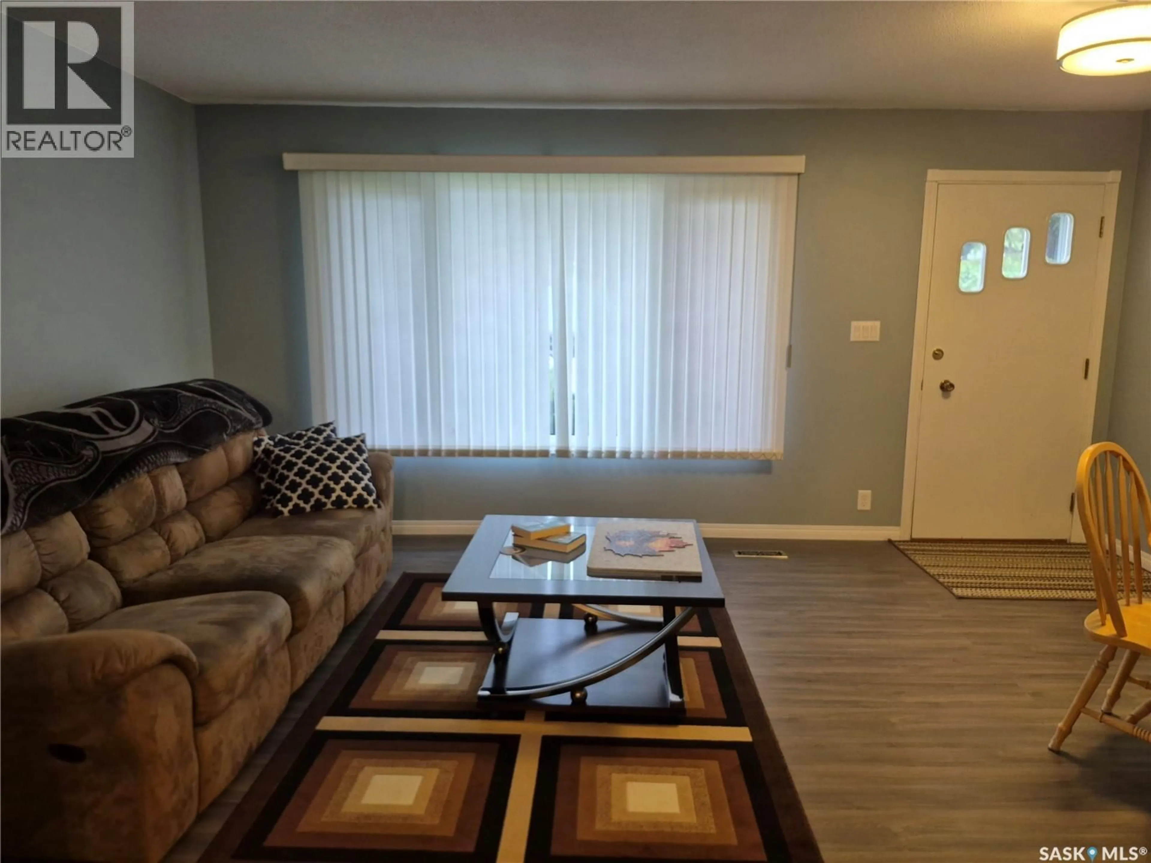 Living room with furniture, wood/laminate floor for 108 DOWNEY STREET, Strasbourg Saskatchewan S0G4V0