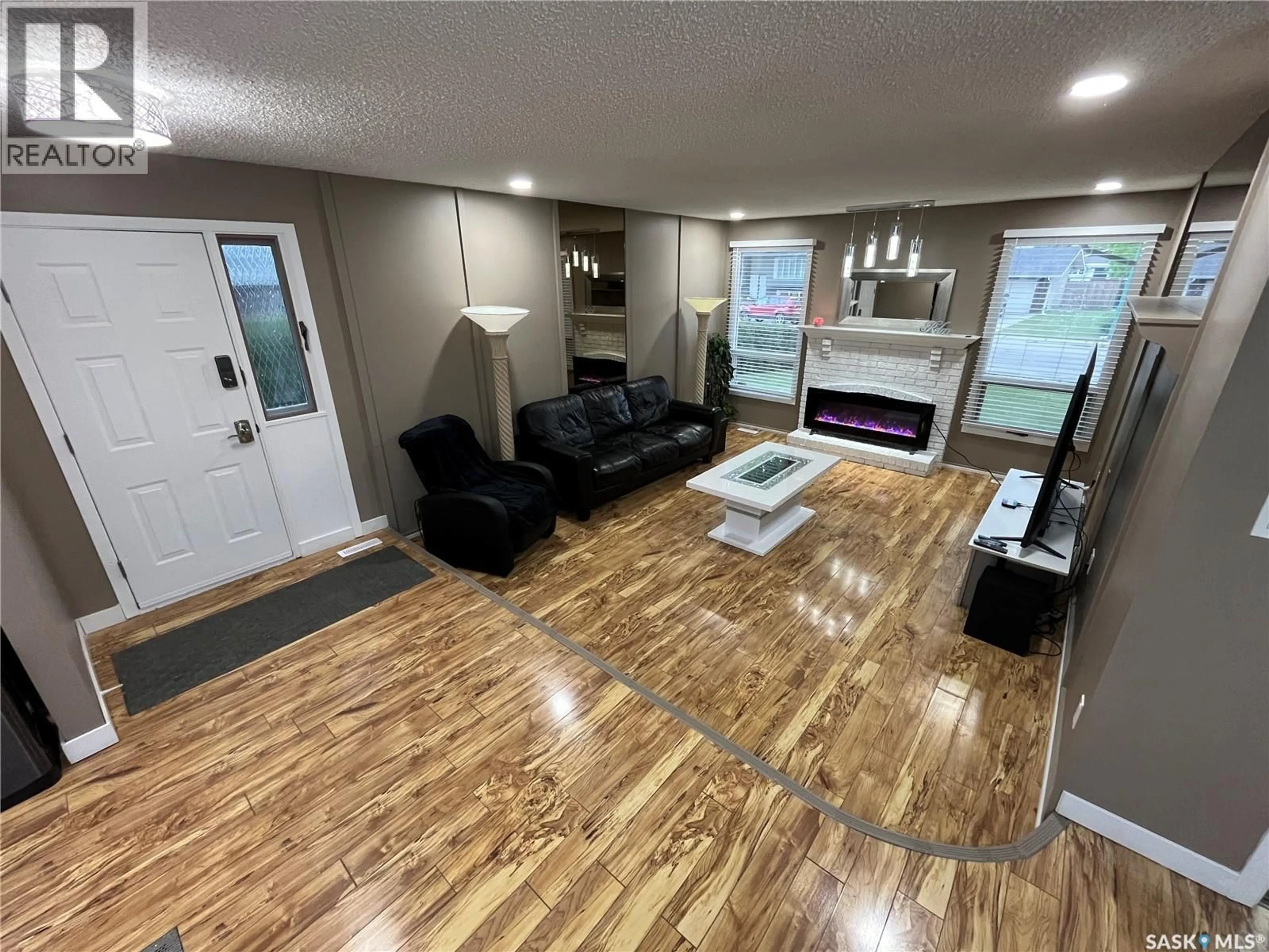 Living room with furniture, wood/laminate floor for 374 RODENBUSH DRIVE, Regina Saskatchewan S4R7L5