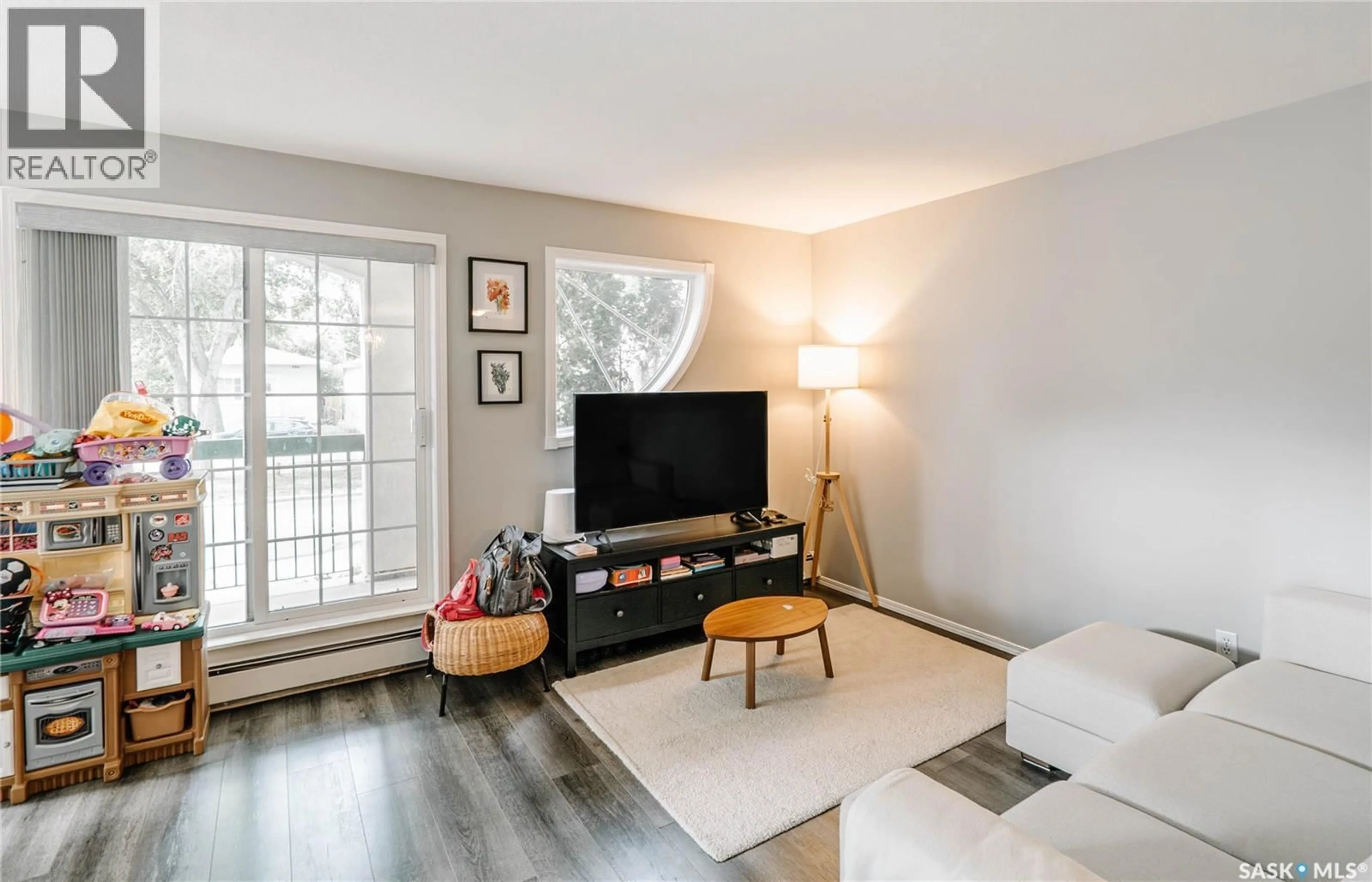 Living room with furniture, wood/laminate floor for 521 - 107 MAIN STREET, Saskatoon Saskatchewan S7N0C2