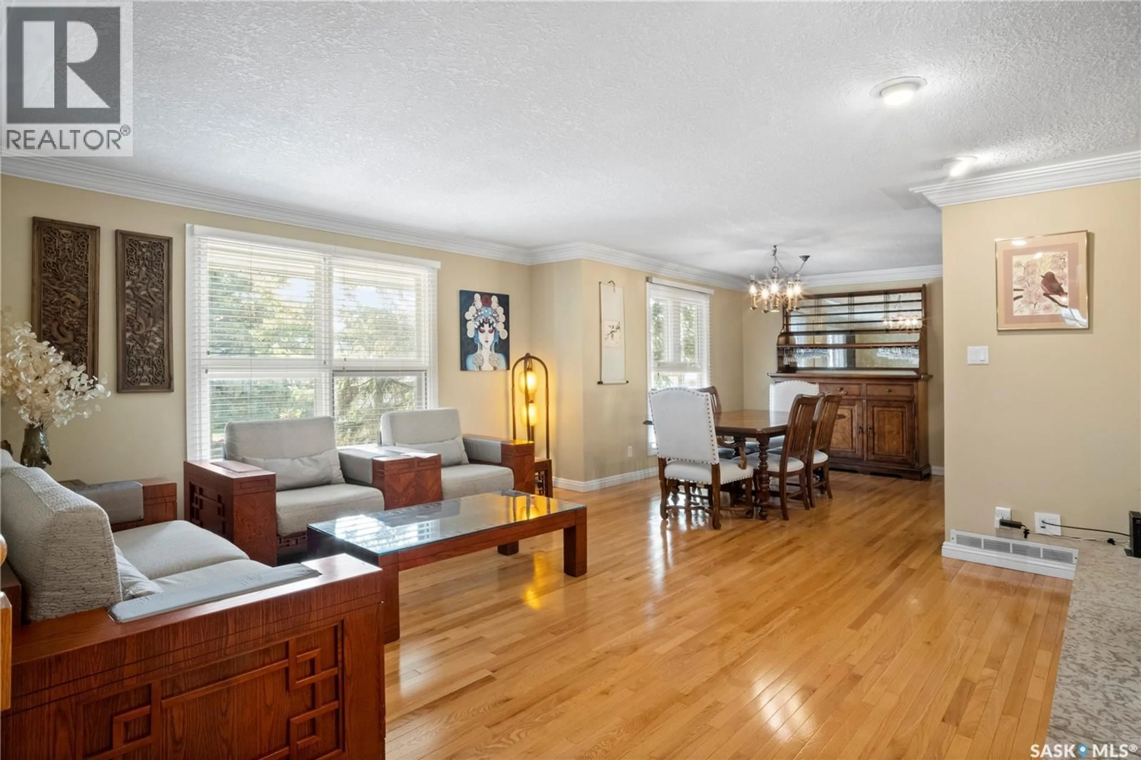 Living room with furniture, wood/laminate floor for 66 LESLIE PLACE, Regina Saskatchewan S4S6R2