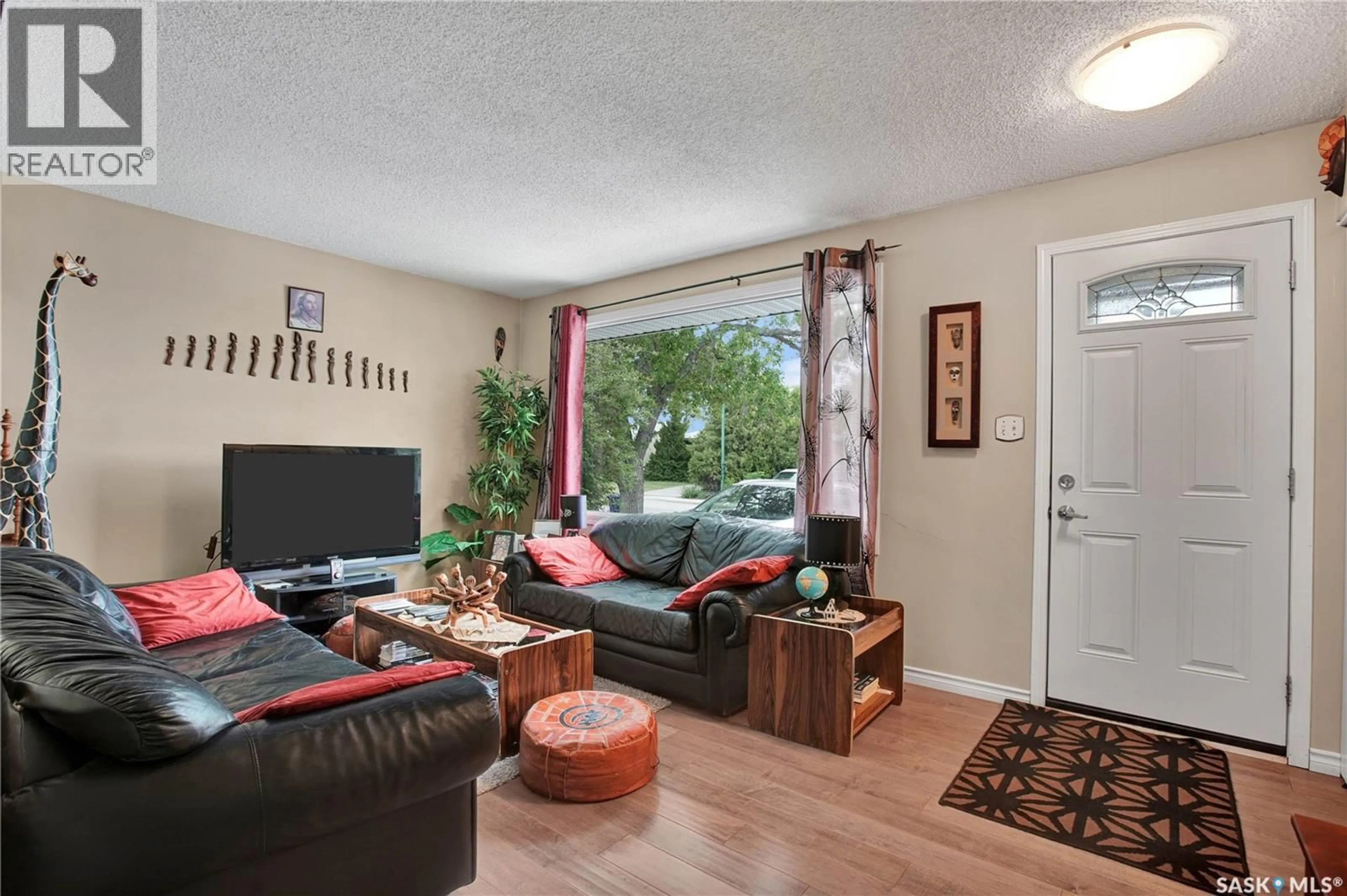 Living room with furniture, wood/laminate floor for 84 RITA CRESCENT, Saskatoon Saskatchewan S7N2L5