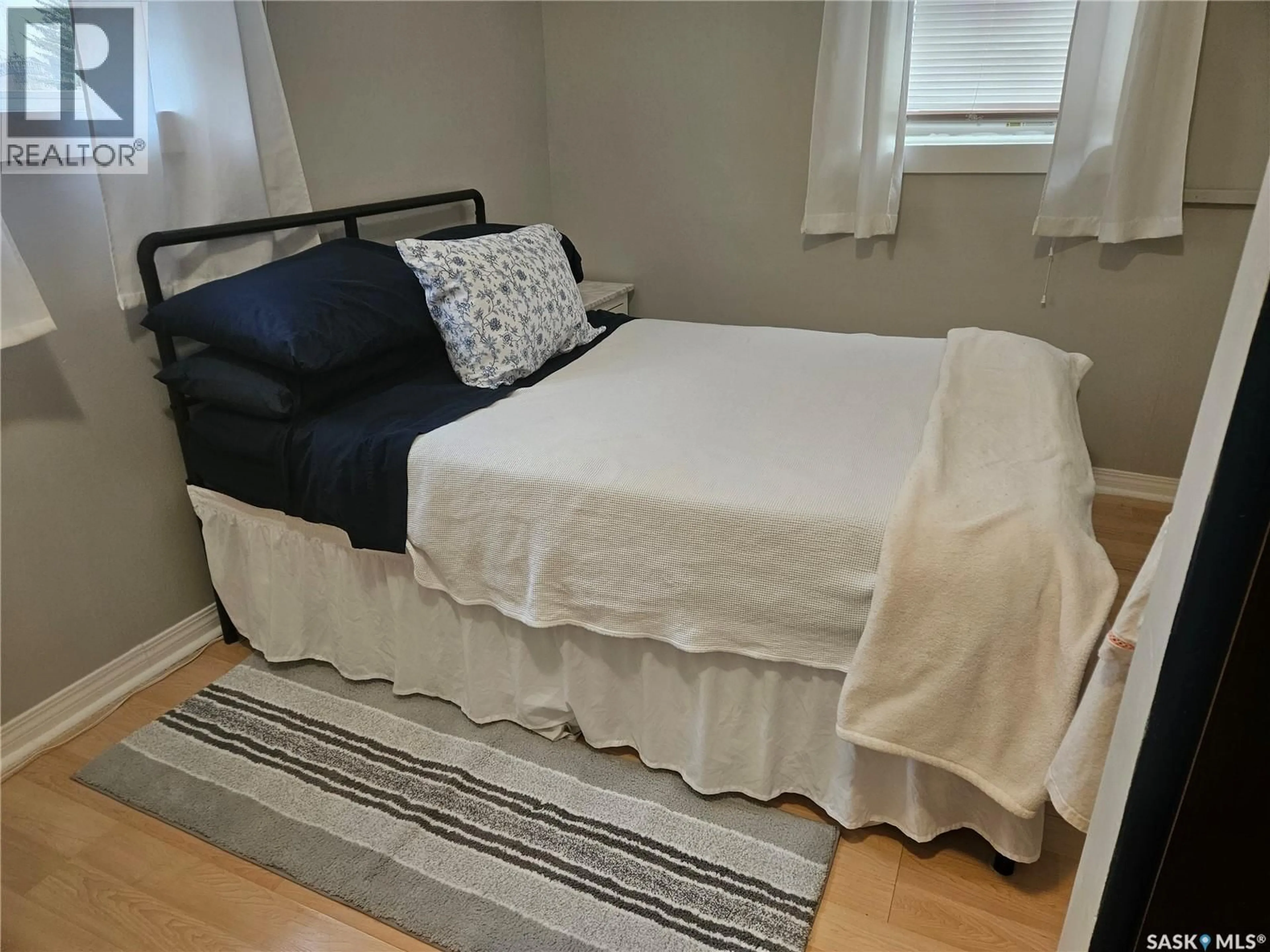 Bedroom with bed, wood/laminate floor for 205 MAIN STREET, Midale Saskatchewan S0C1S0