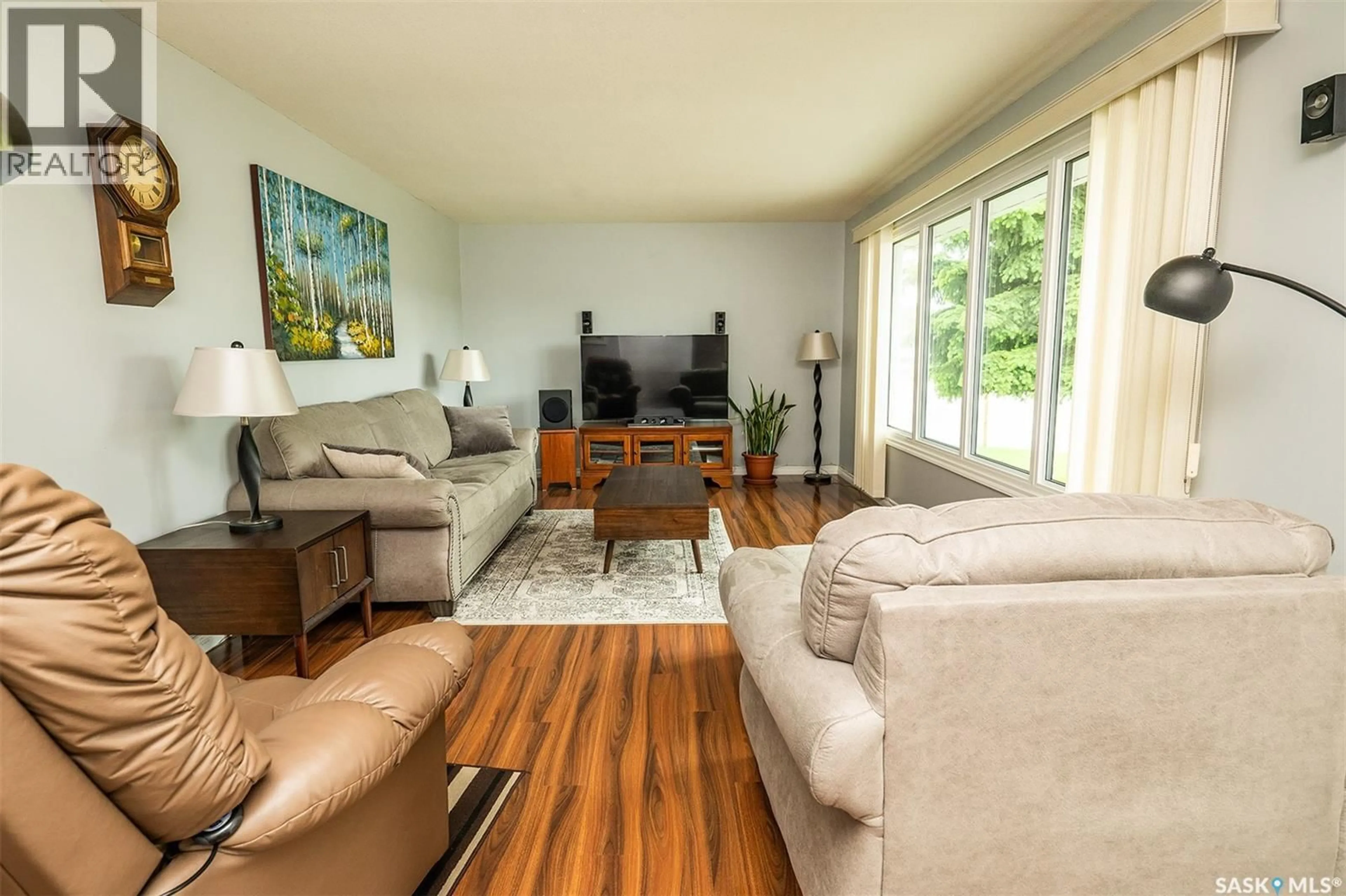 Living room with furniture, wood/laminate floor for 217 8TH STREET, Wynyard Saskatchewan S0A4T0