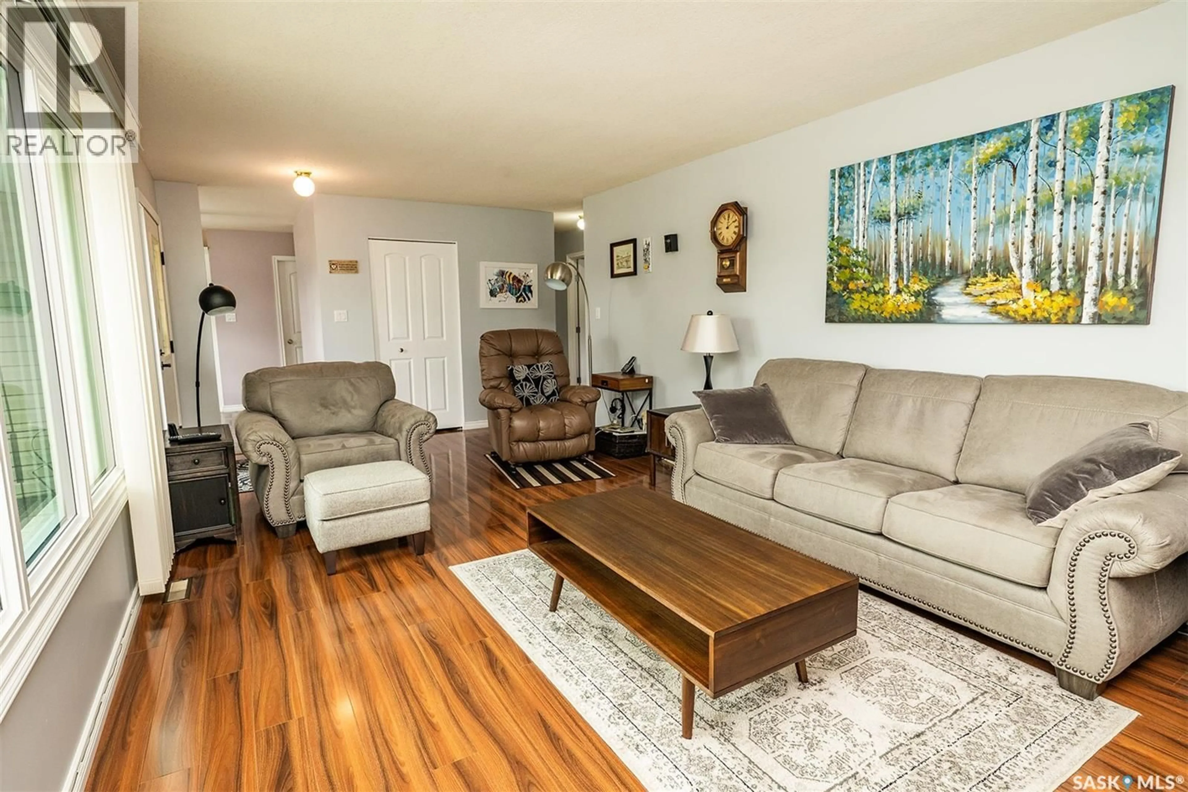 Living room with furniture, wood/laminate floor for 217 8TH STREET, Wynyard Saskatchewan S0A4T0