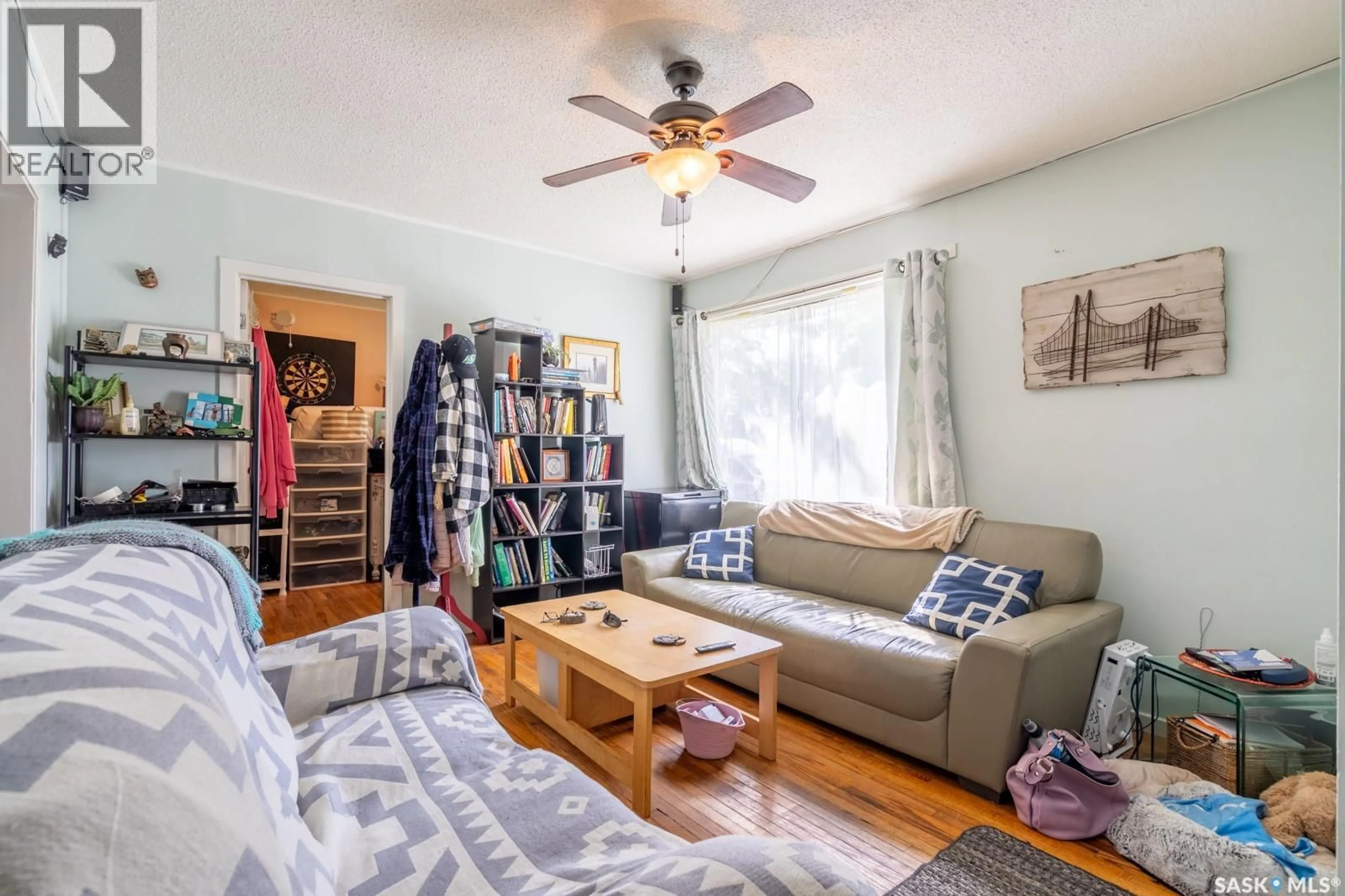 Living room with furniture, wood/laminate floor for 3 INGERSOLL CRESCENT, Regina Saskatchewan S4T5Y8