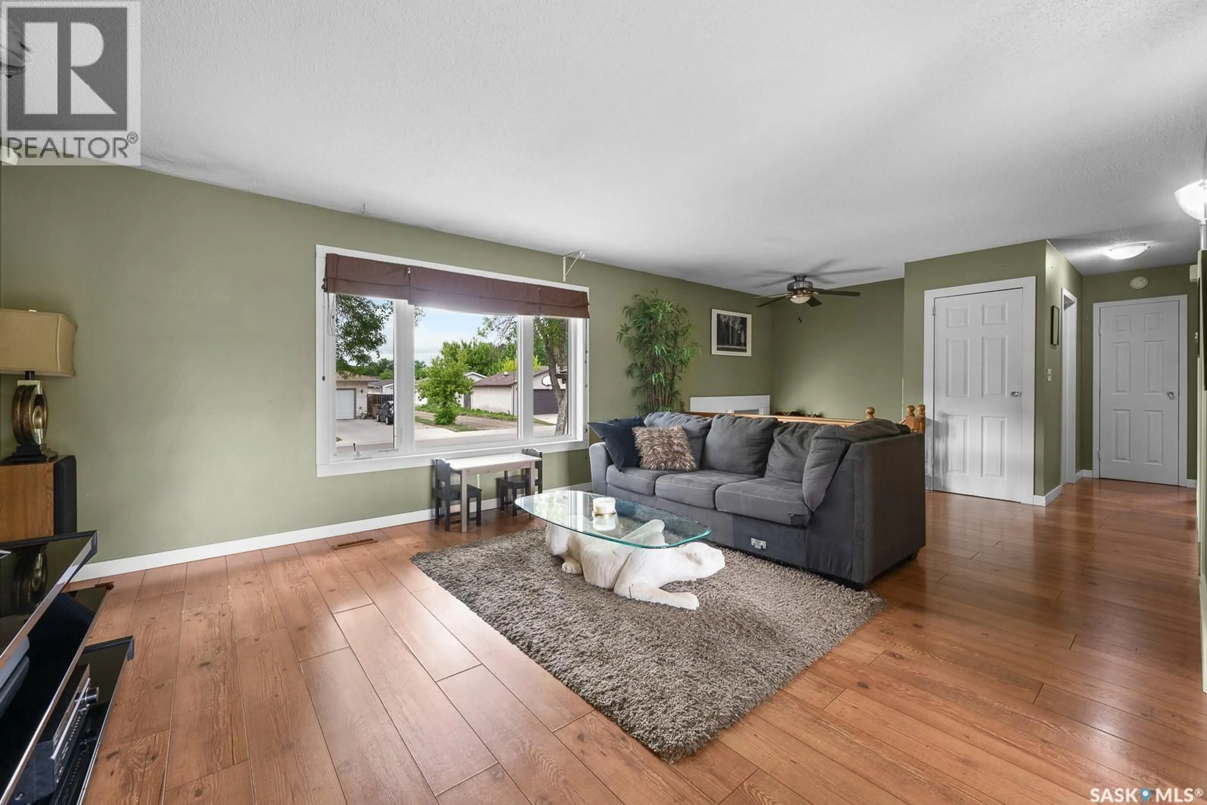 Living room with furniture, wood/laminate floor for 10 BASTEDO CRESCENT, Regina Saskatchewan S4T6X9