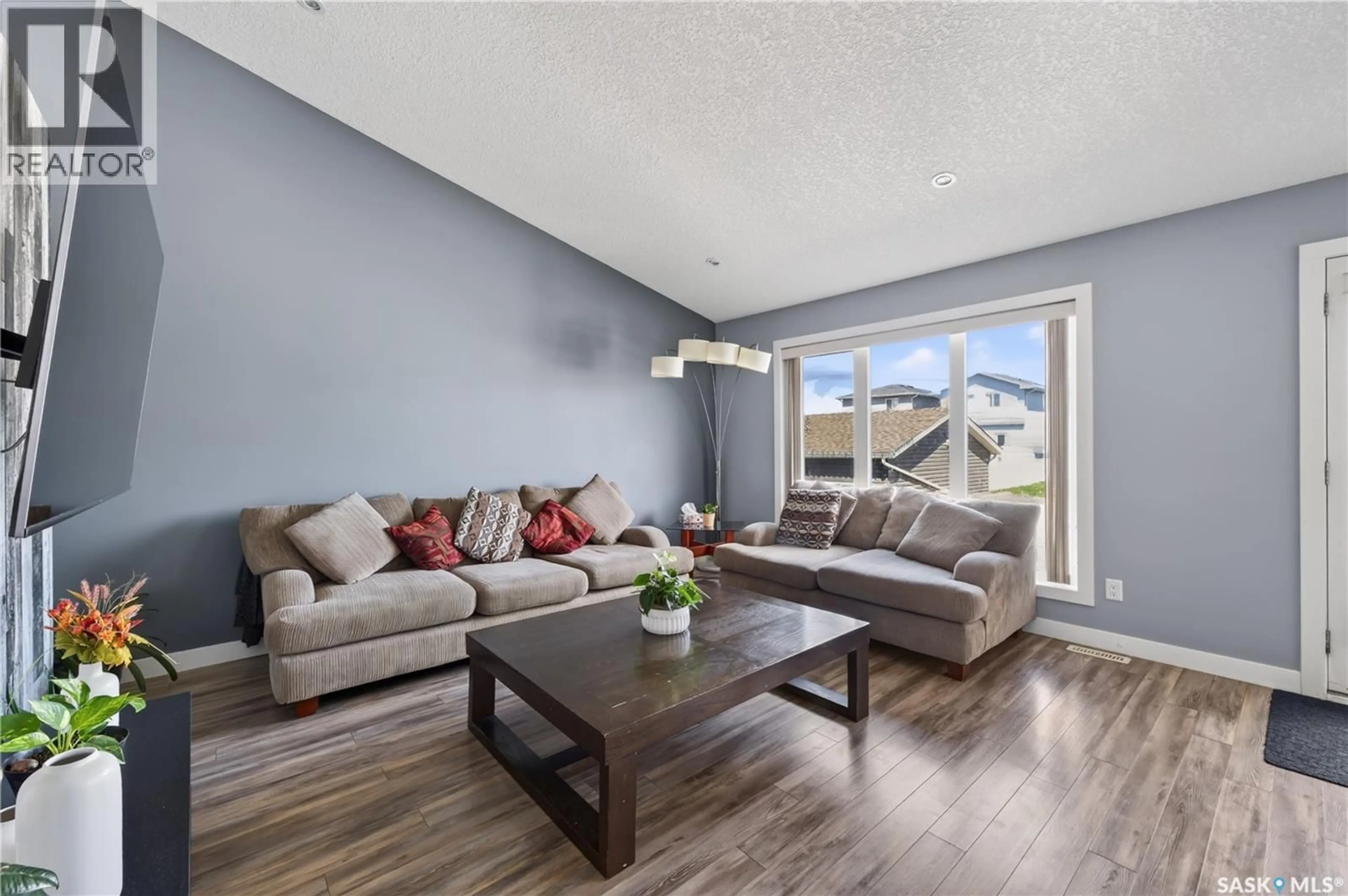Living room with furniture, wood/laminate floor for 4461 JAMES HILL ROAD, Regina Saskatchewan S4W0K5