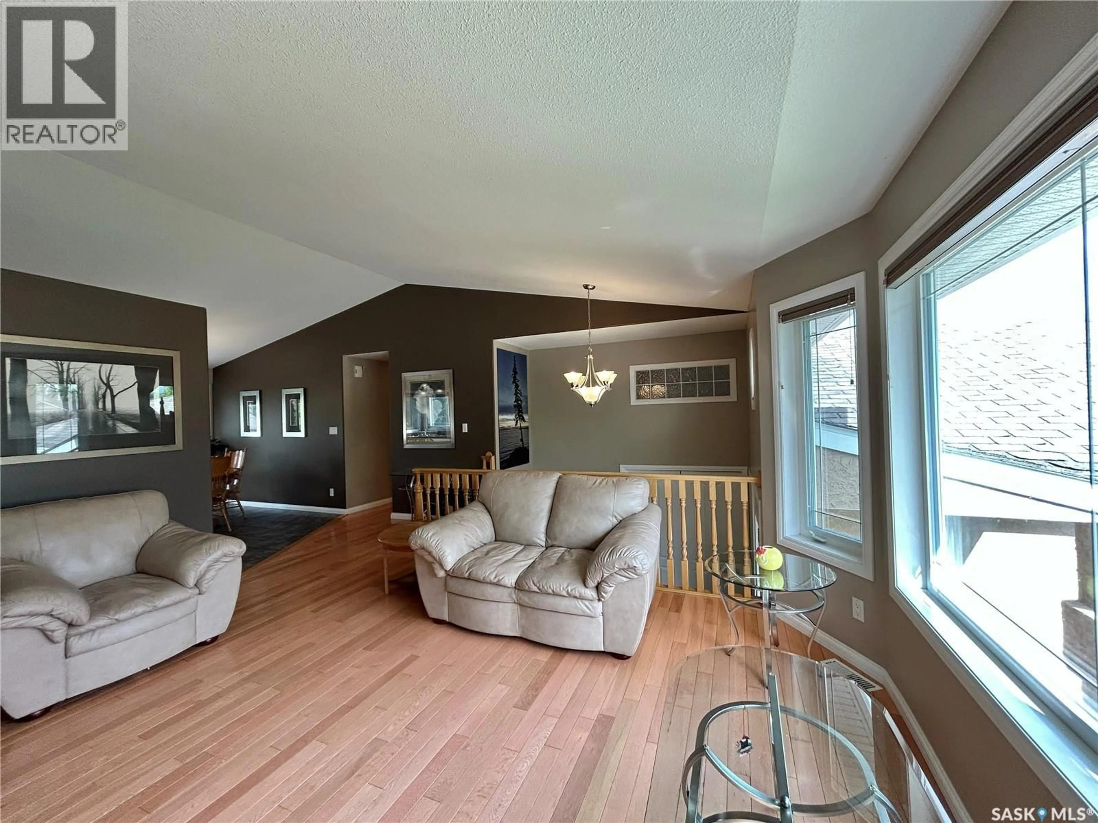 Living room with furniture, wood/laminate floor for 71 LONGPRE CRESCENT, Prince Albert Saskatchewan S6X1C6