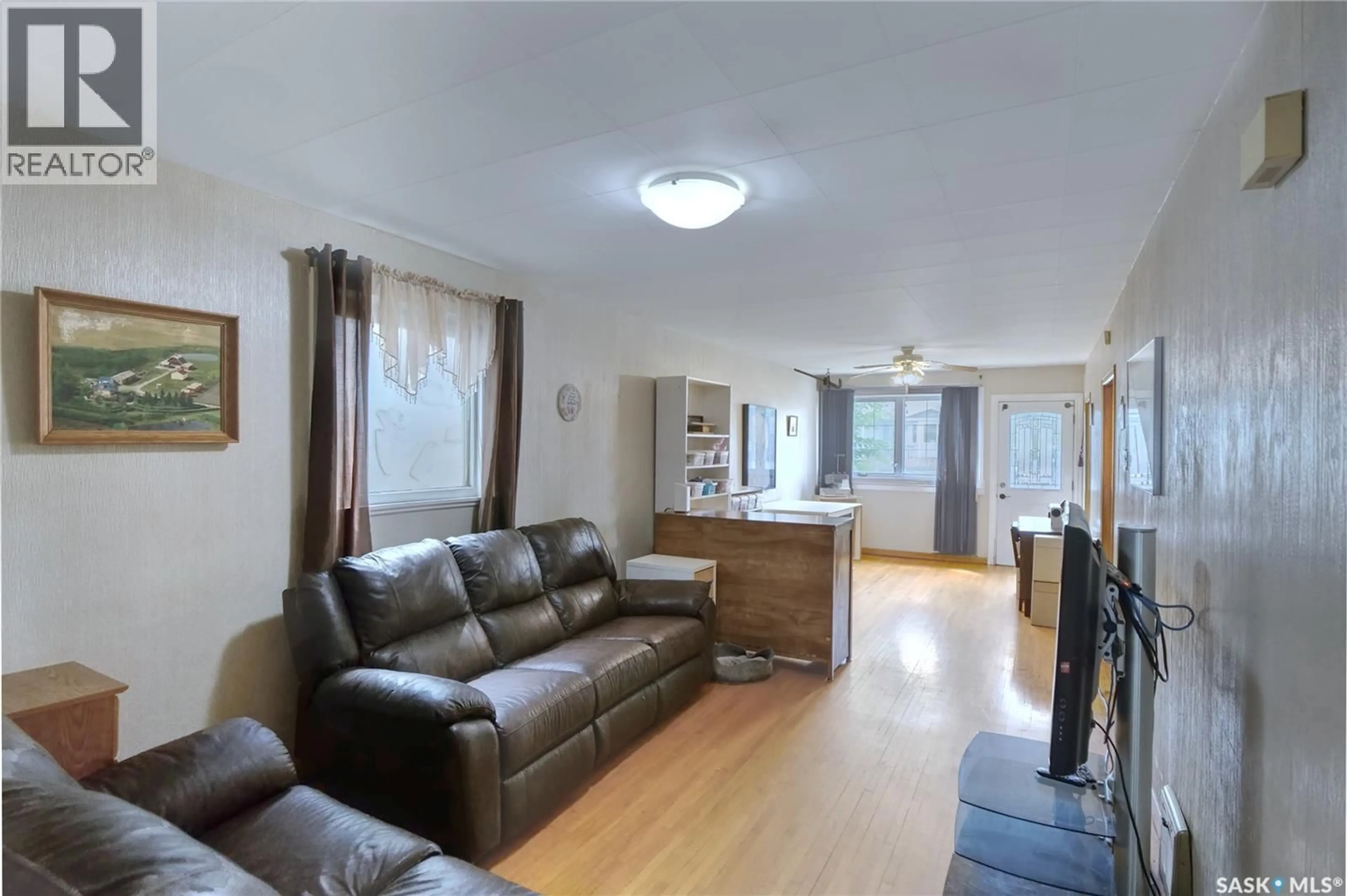 Living room with furniture, wood/laminate floor for 460 IROQUOIS STREET, Moose Jaw Saskatchewan S6H5B3