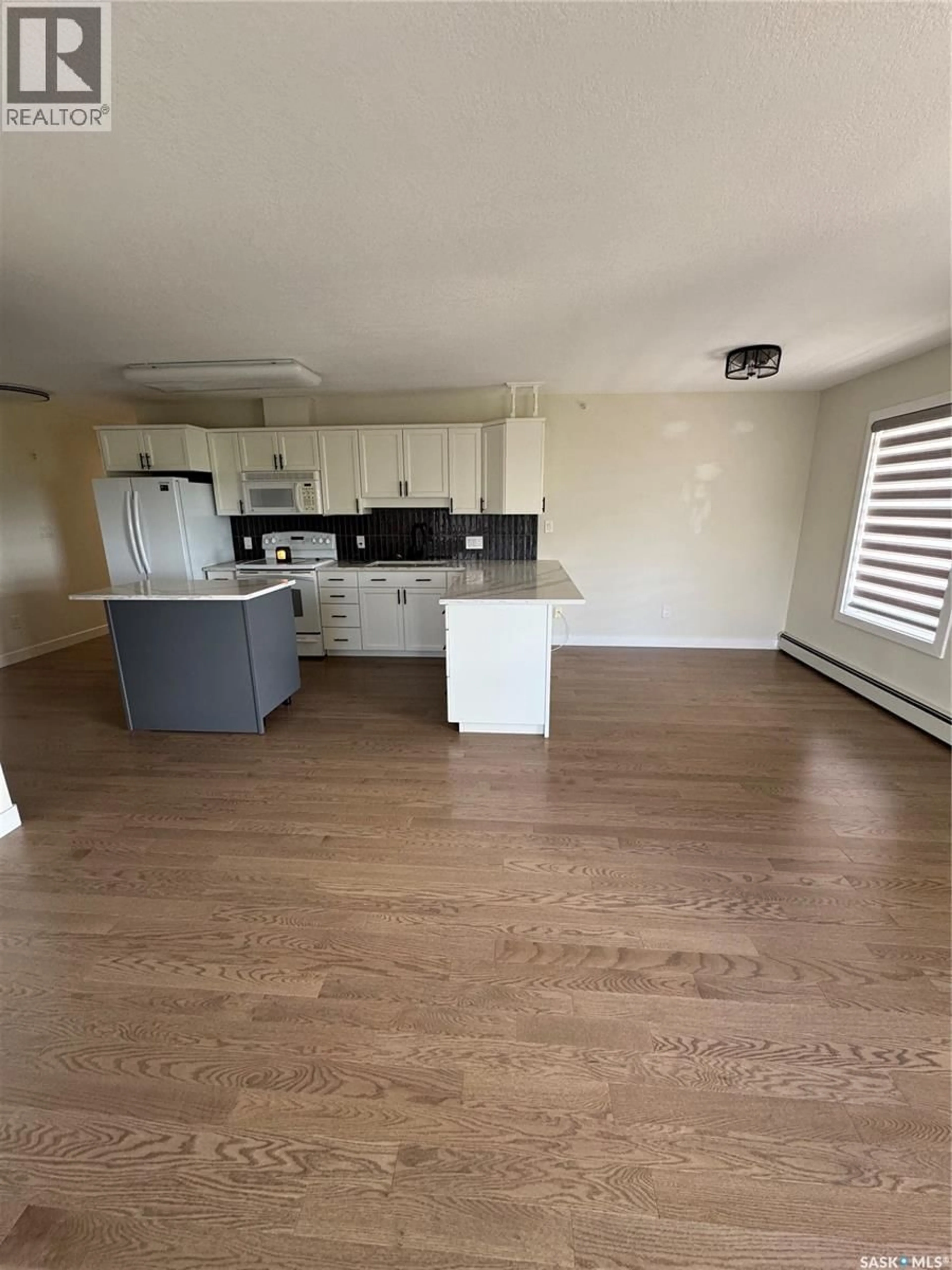 Open concept kitchen, wood/laminate floor for 304 - 1601 1ST STREET, Estevan Saskatchewan S4A0C3