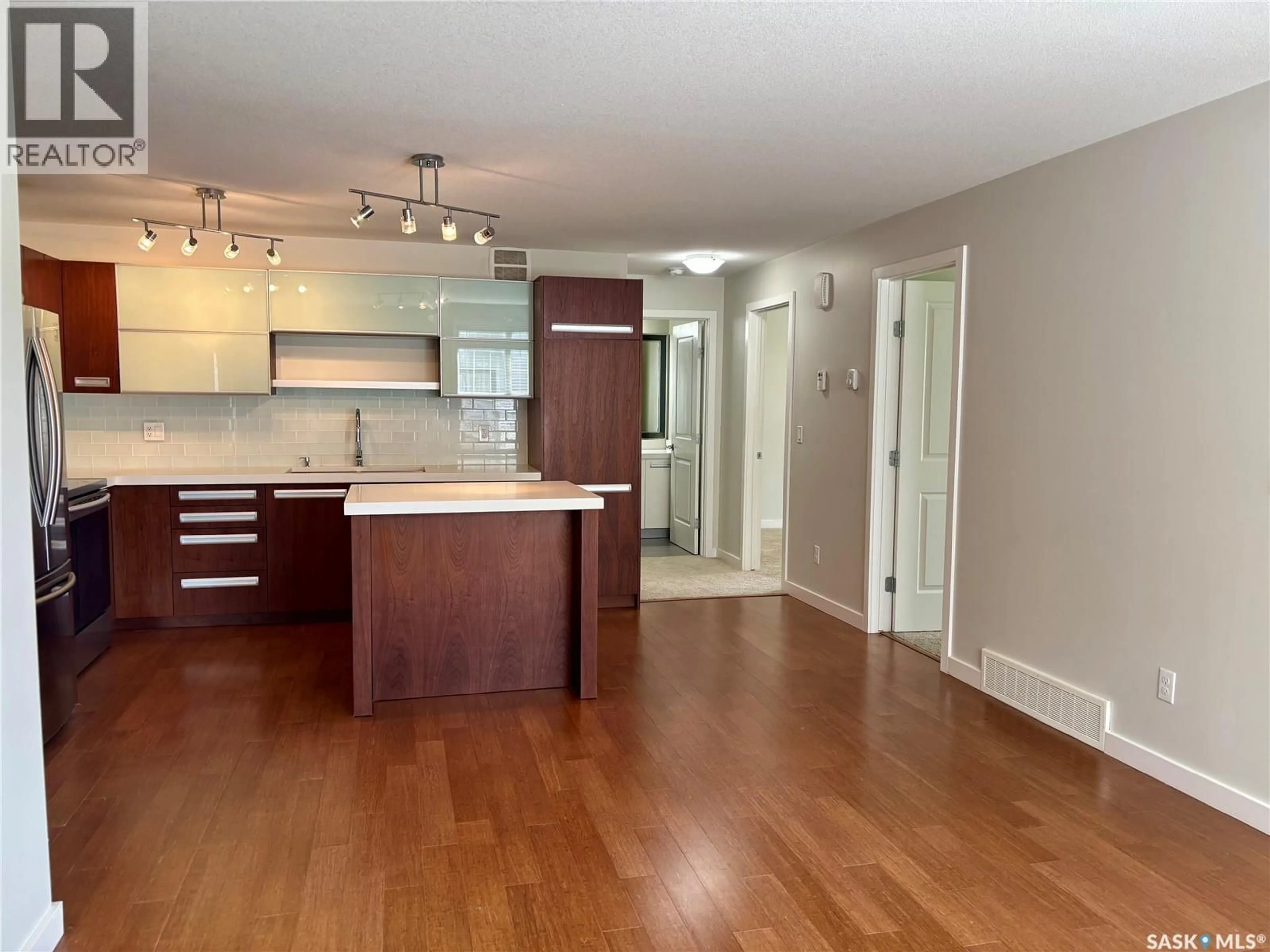 Open concept kitchen, wood/laminate floor for 1015 - 801 PATRICK CRESCENT, Saskatoon Saskatchewan S7W0M4