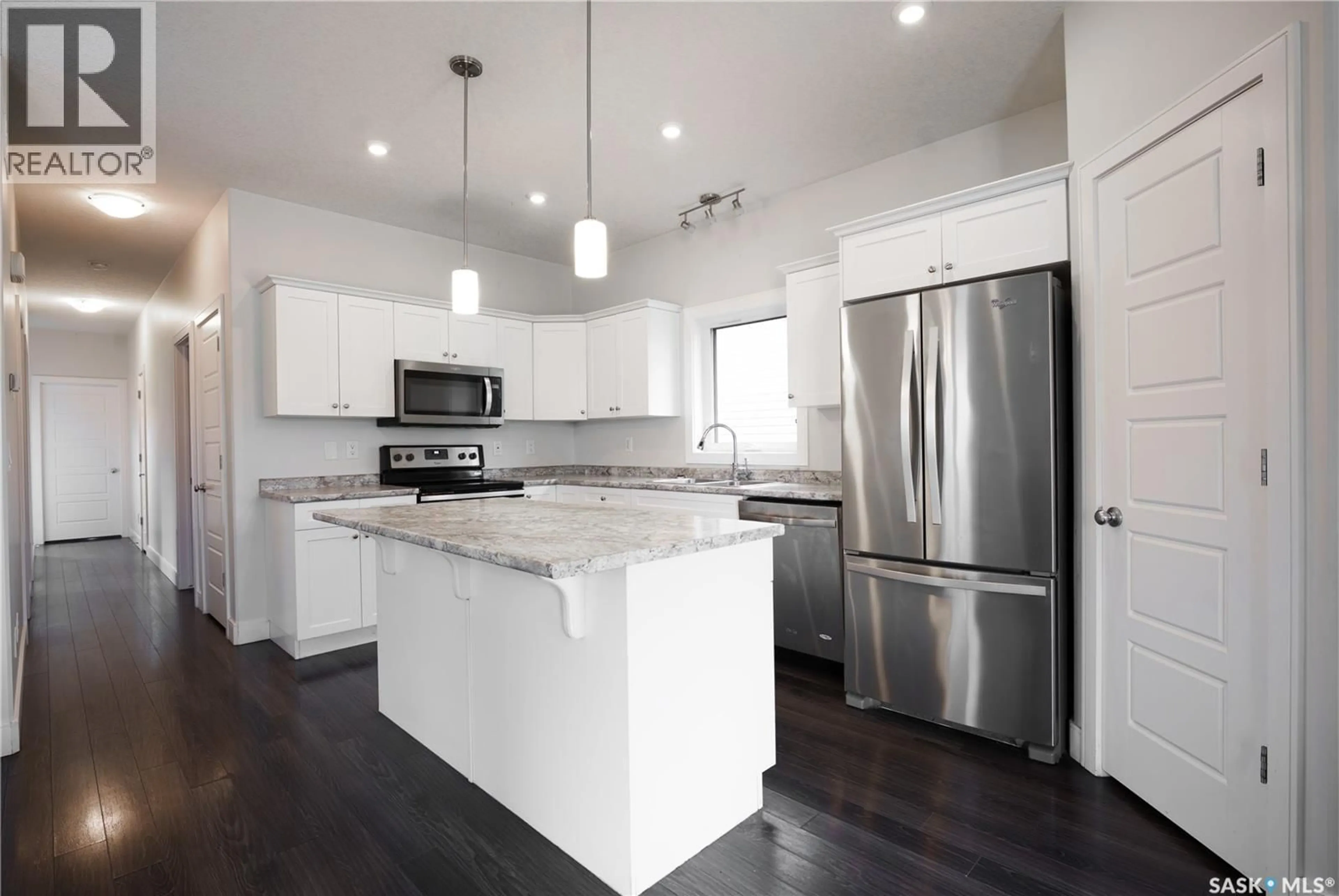 Open concept kitchen, wood/laminate floor for 646 KOLYNCHUK COURT, Saskatoon Saskatchewan S7T0W2
