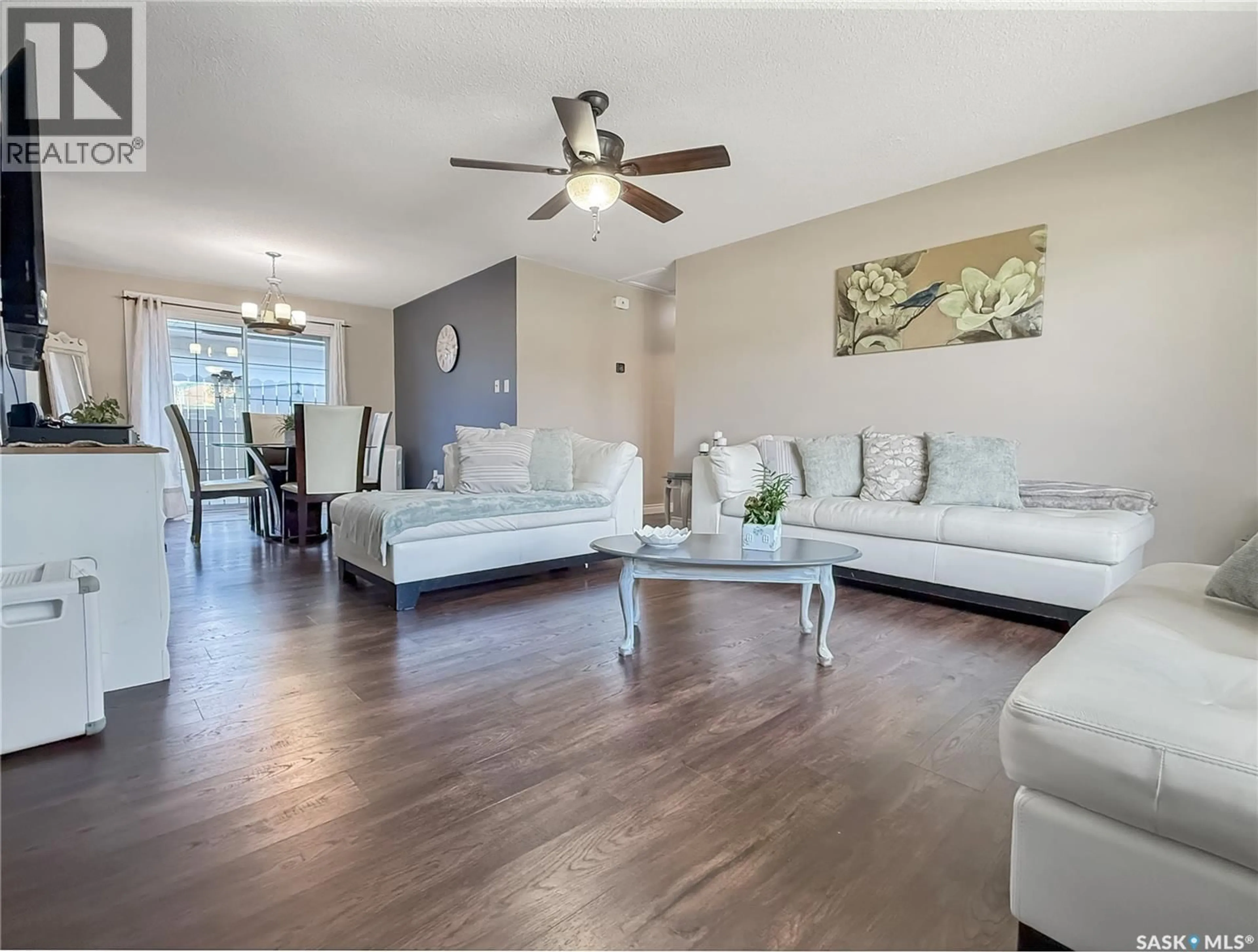 Living room with furniture, wood/laminate floor for 890 10TH AVENUE, Swift Current Saskatchewan S9H2T7