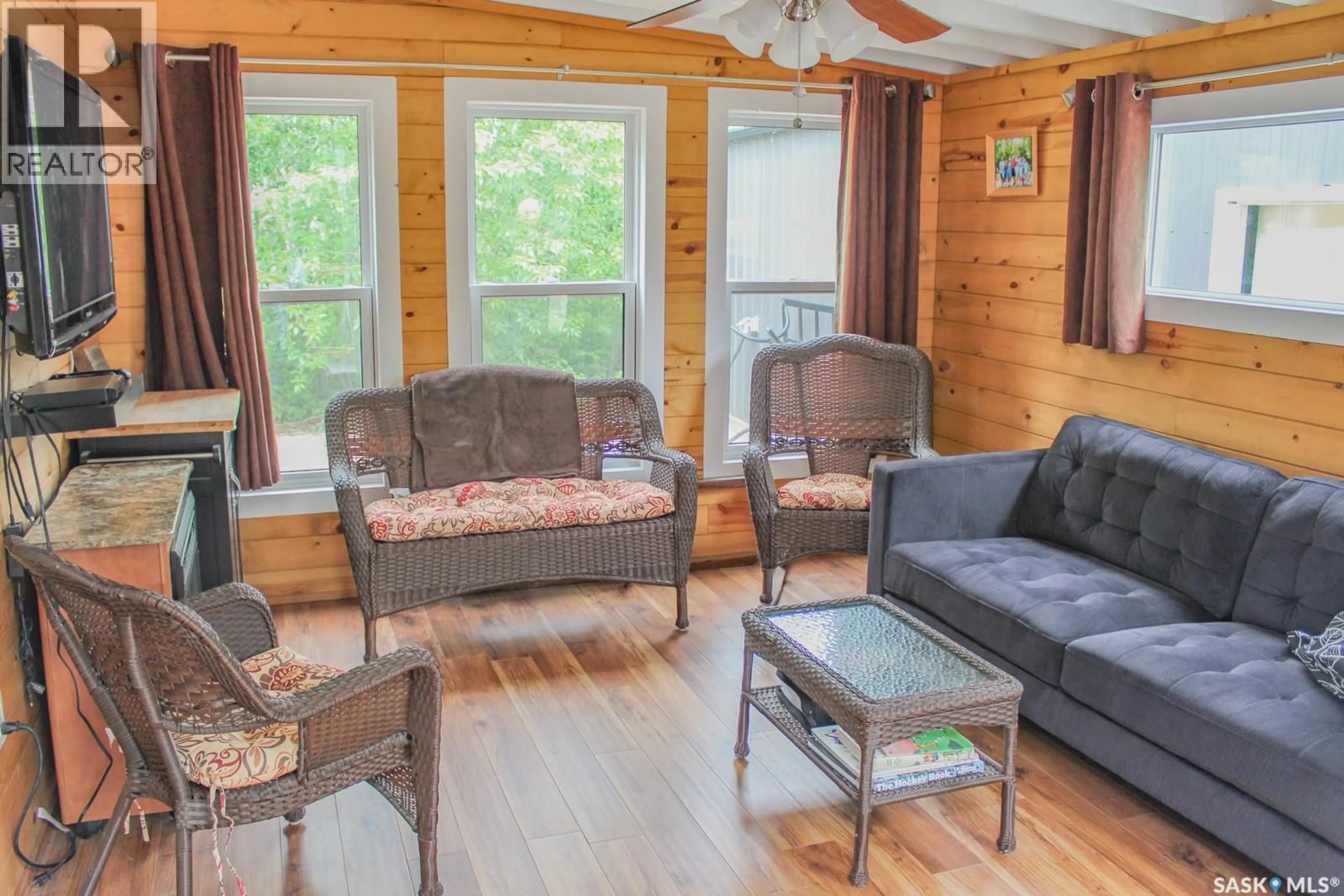 Living room with furniture, wood/laminate floor for 101 POPLAR STREET, St. Brieux Saskatchewan S0K1V0