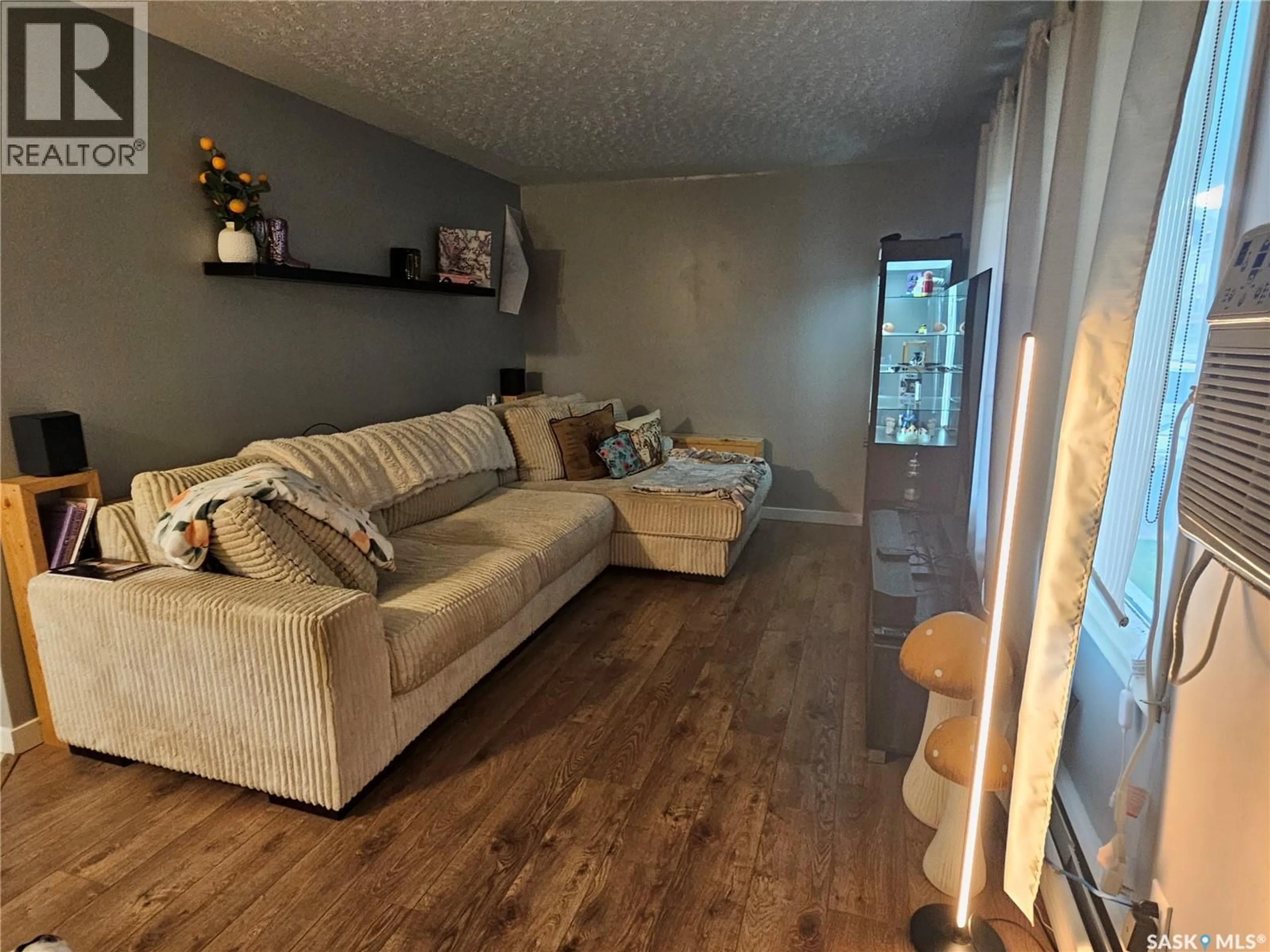 Living room with furniture, wood/laminate floor for 1290 WOLFE AVENUE, Moose Jaw Saskatchewan S6H1K2