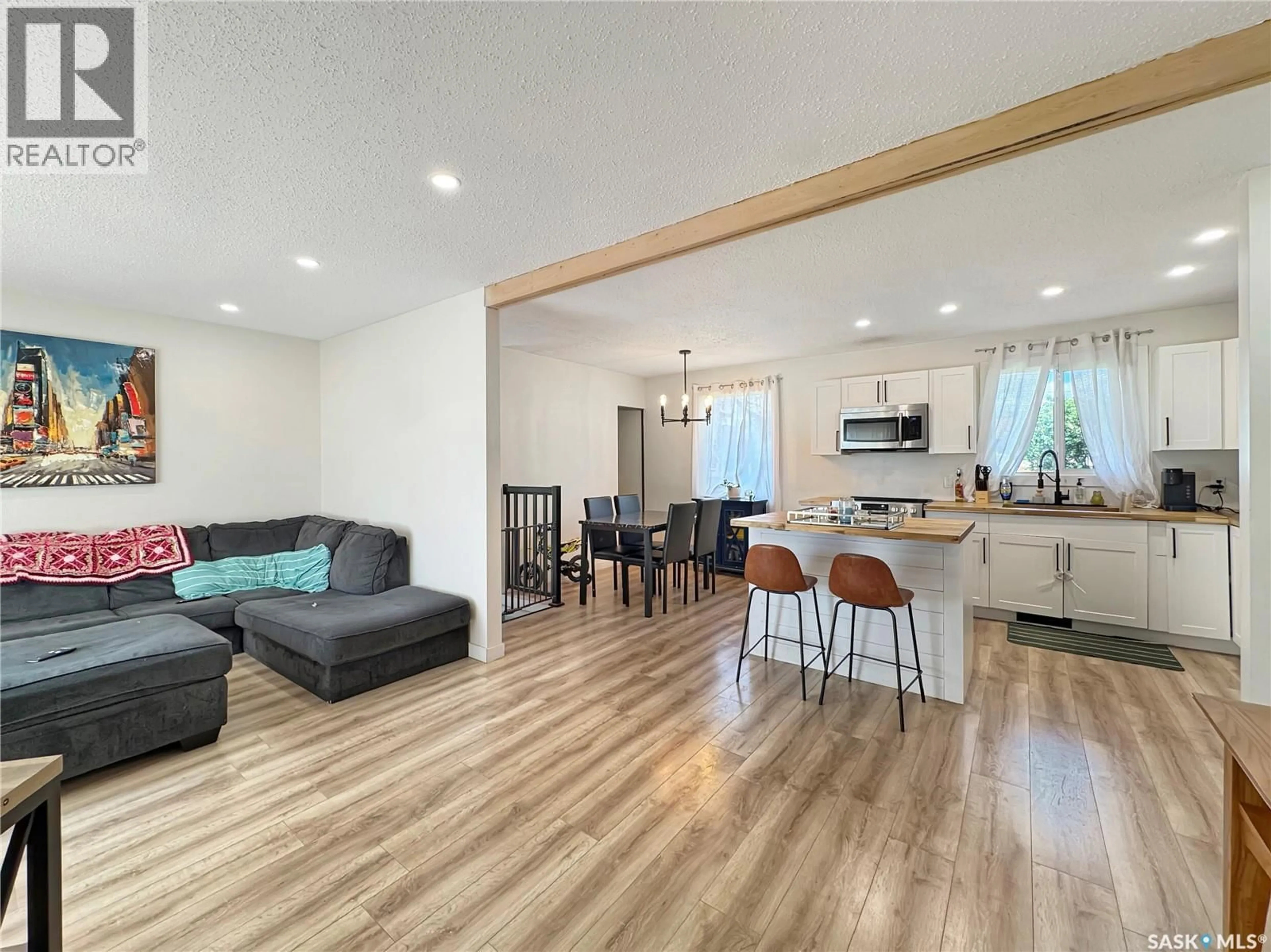 Living room with furniture, wood/laminate floor for 1321 108TH STREET, North Battleford Saskatchewan S9A2B6