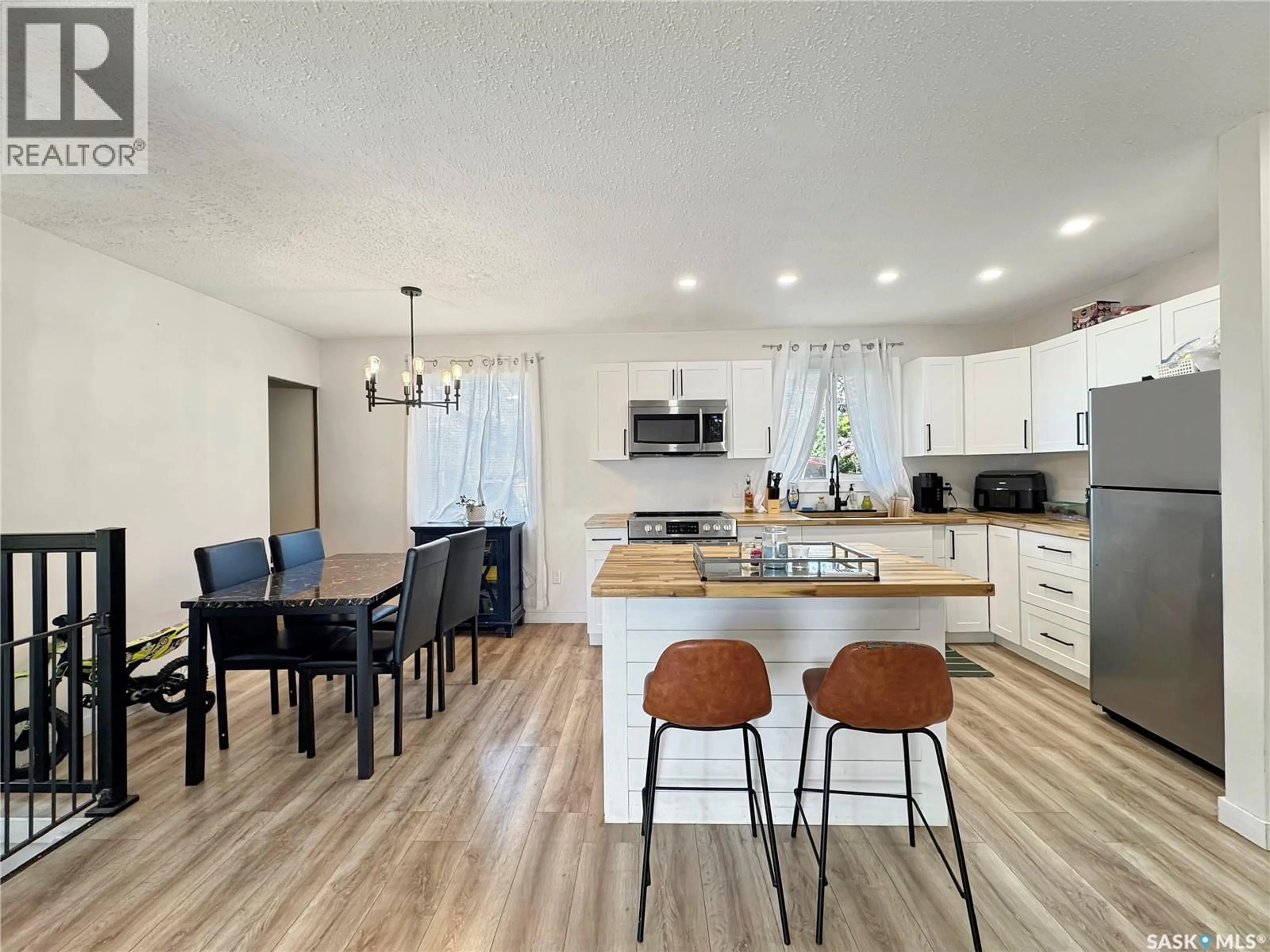 Open concept kitchen, wood/laminate floor for 1321 108TH STREET, North Battleford Saskatchewan S9A2B6
