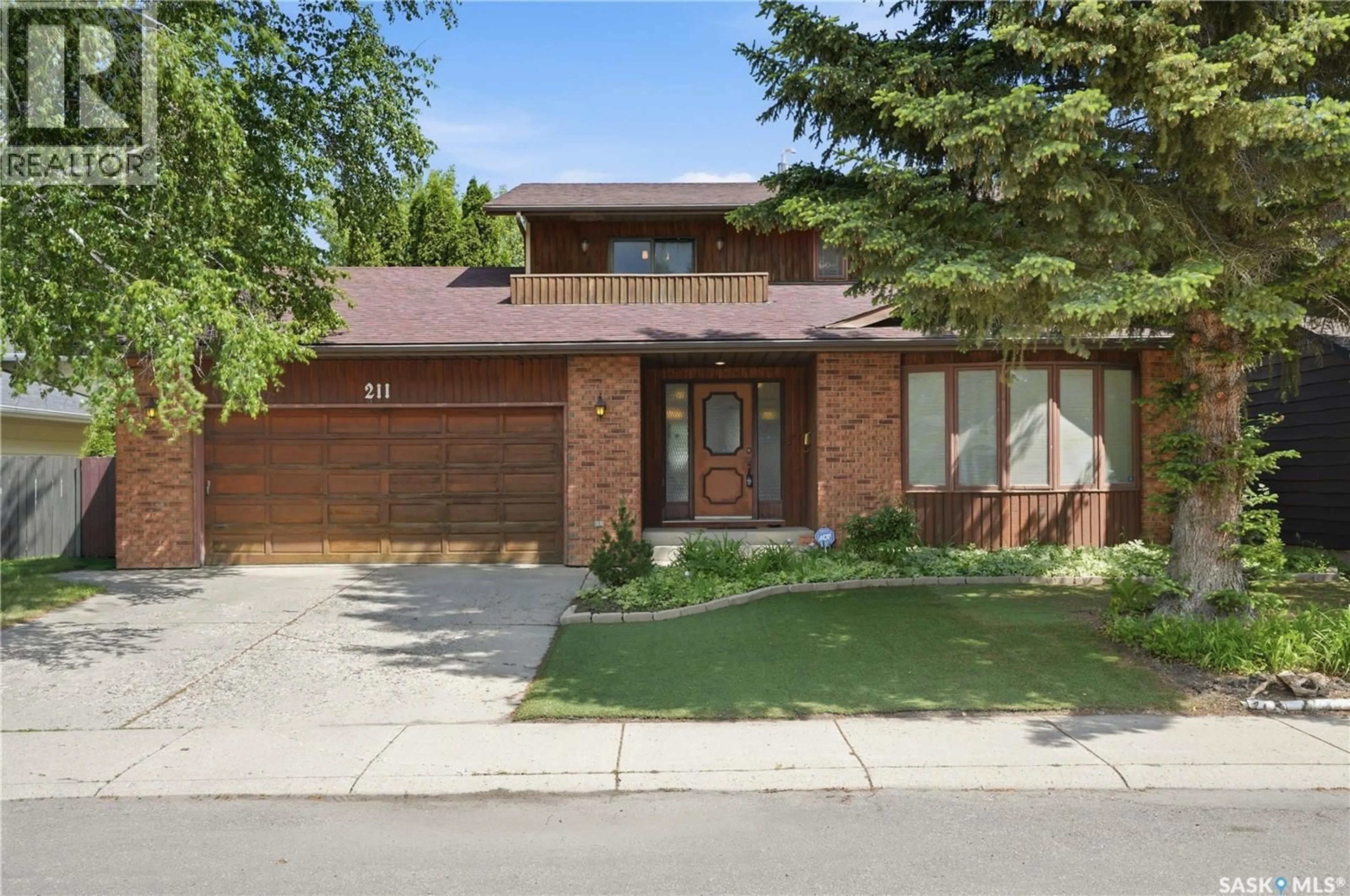 Home with brick exterior material, street for 211 KEELEY CRESCENT, Saskatoon Saskatchewan S7J4B9