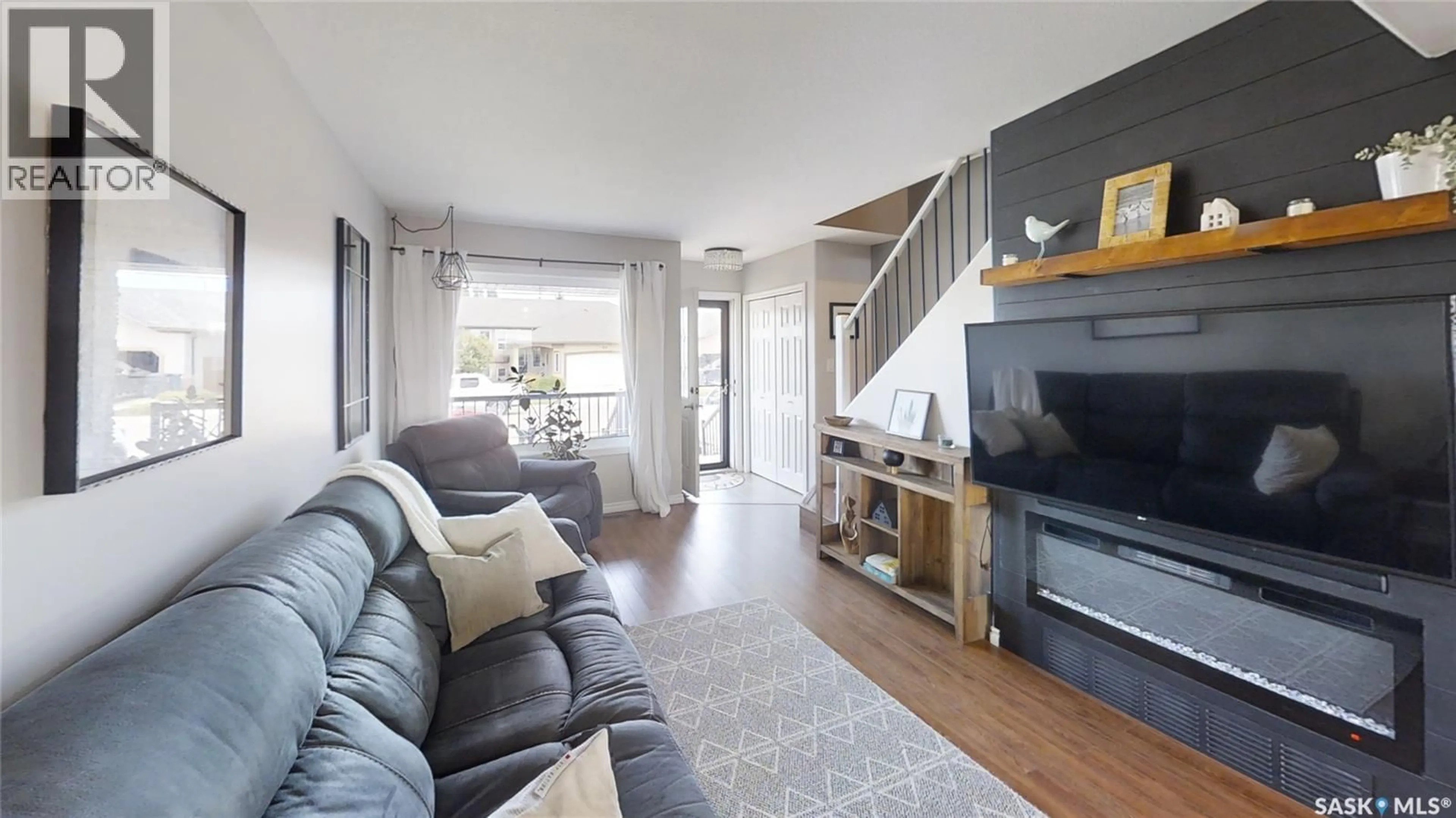 Living room with furniture, wood/laminate floor for 431 BROOKLYN CRESCENT, Warman Saskatchewan S0K0A1