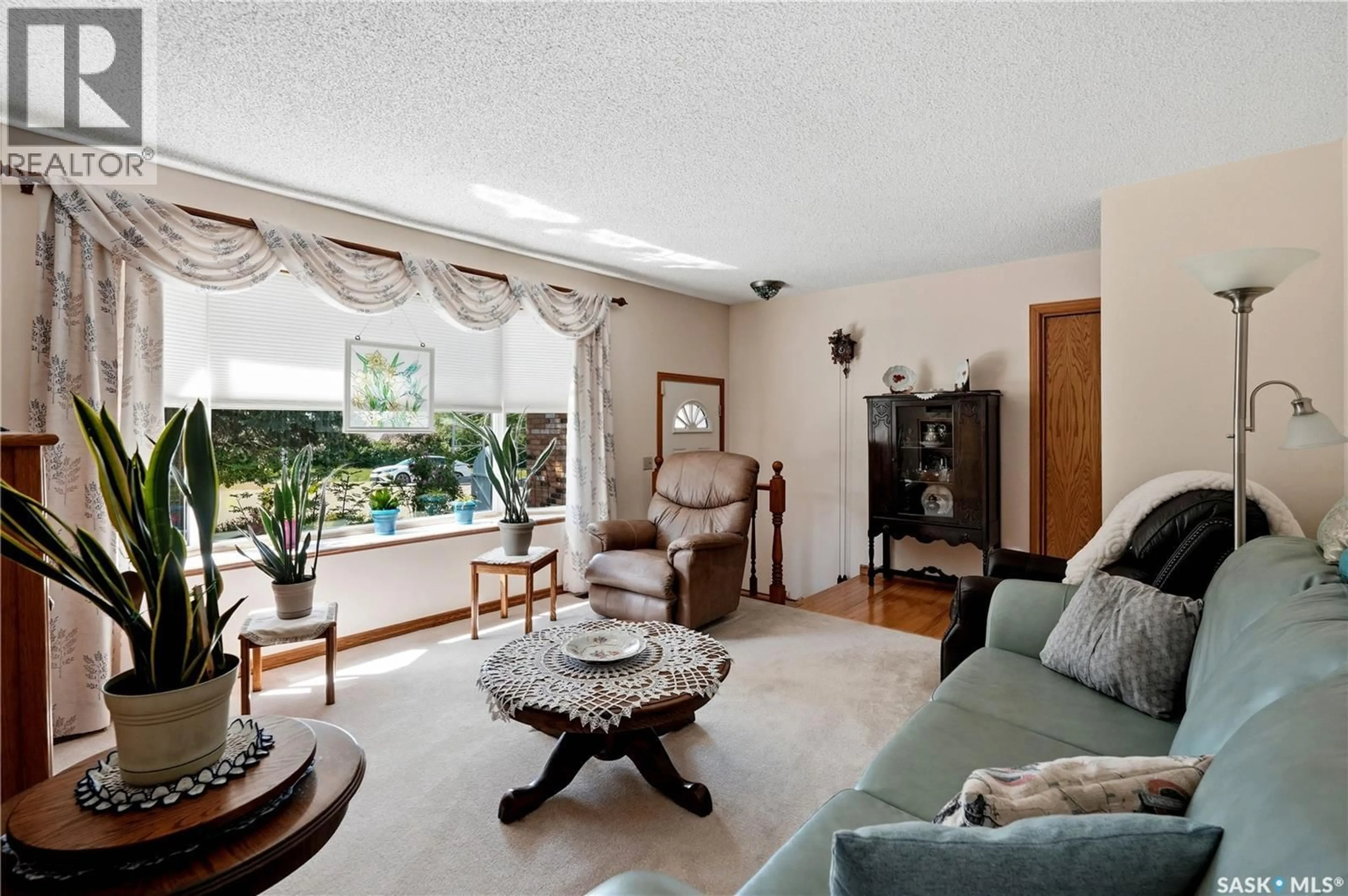 Living room with furniture, ceramic/tile floor for 710 3RD AVENUE, Pilot Butte Saskatchewan S0G0H5