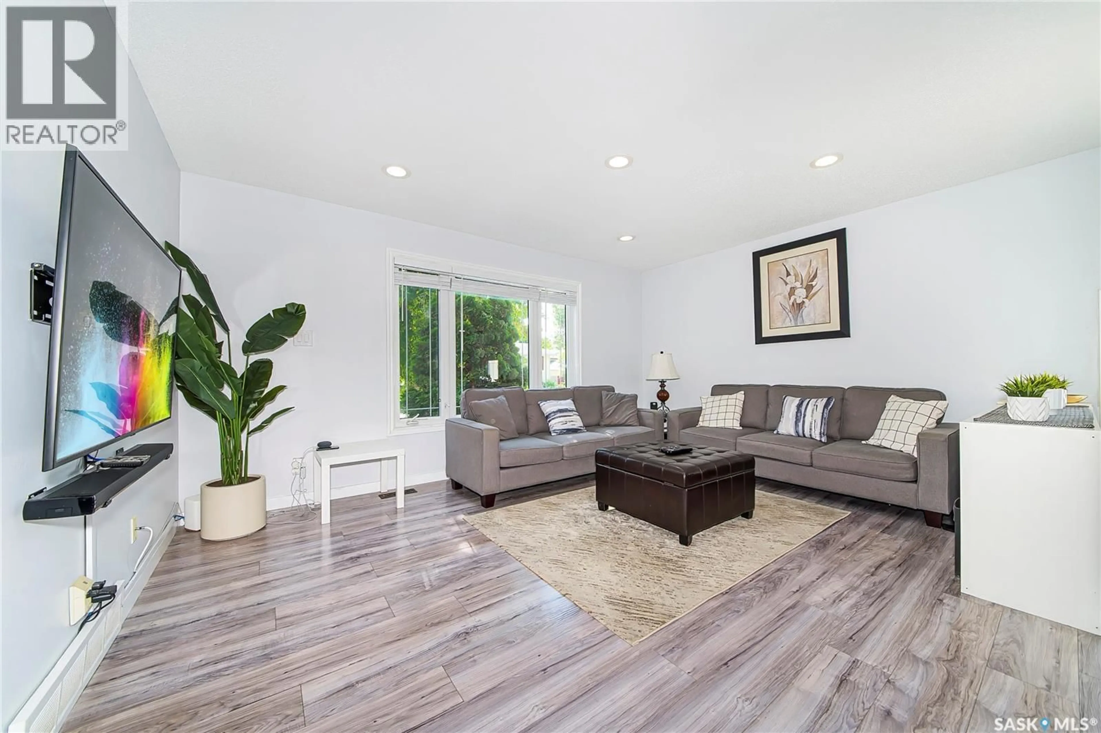 Living room with furniture, wood/laminate floor for 555 NORDSTRUM ROAD, Saskatoon Saskatchewan S7K7X6