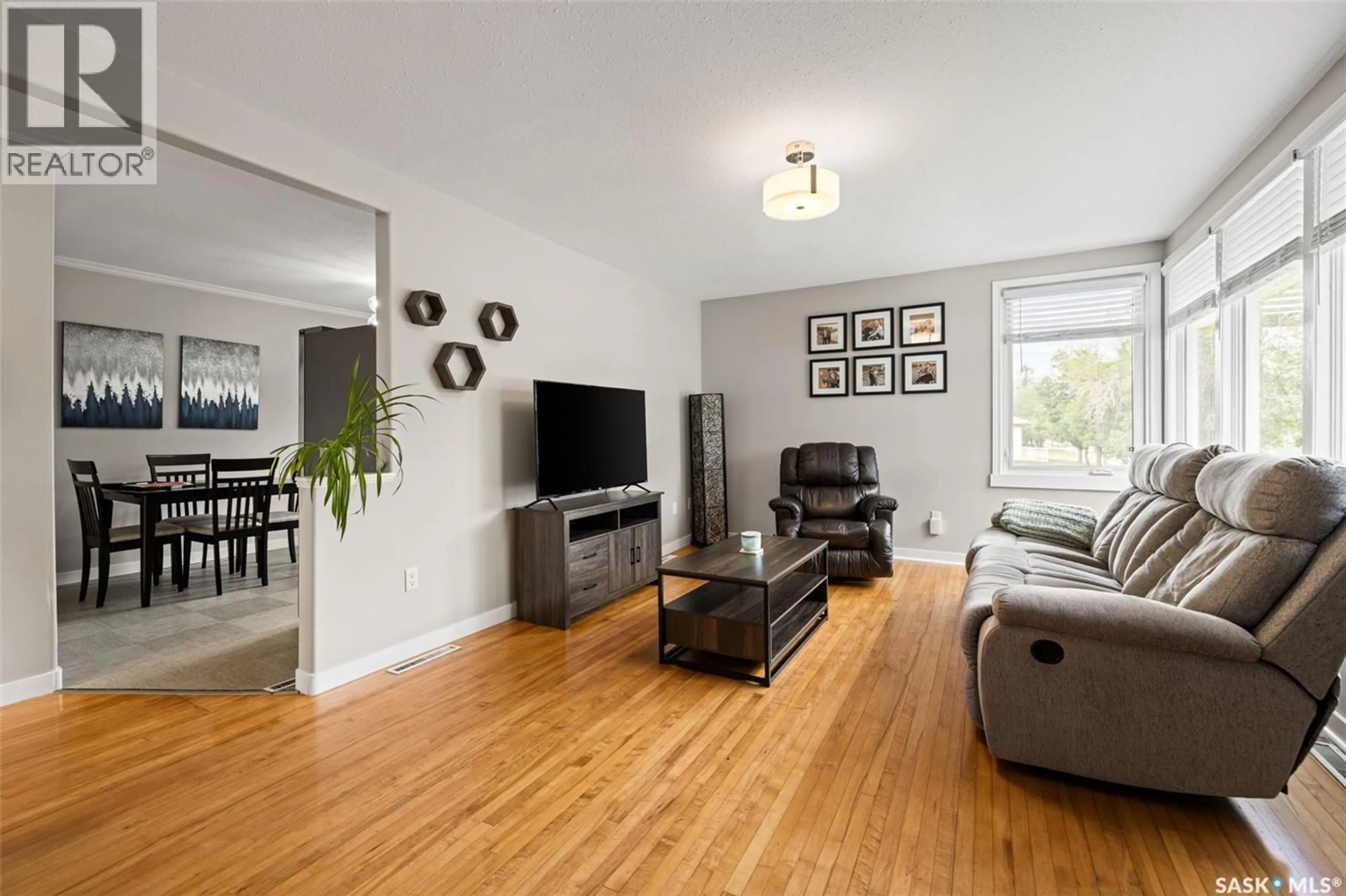 Living room with furniture, wood/laminate floor for 4835 7TH AVENUE, Regina Saskatchewan S4T0R8