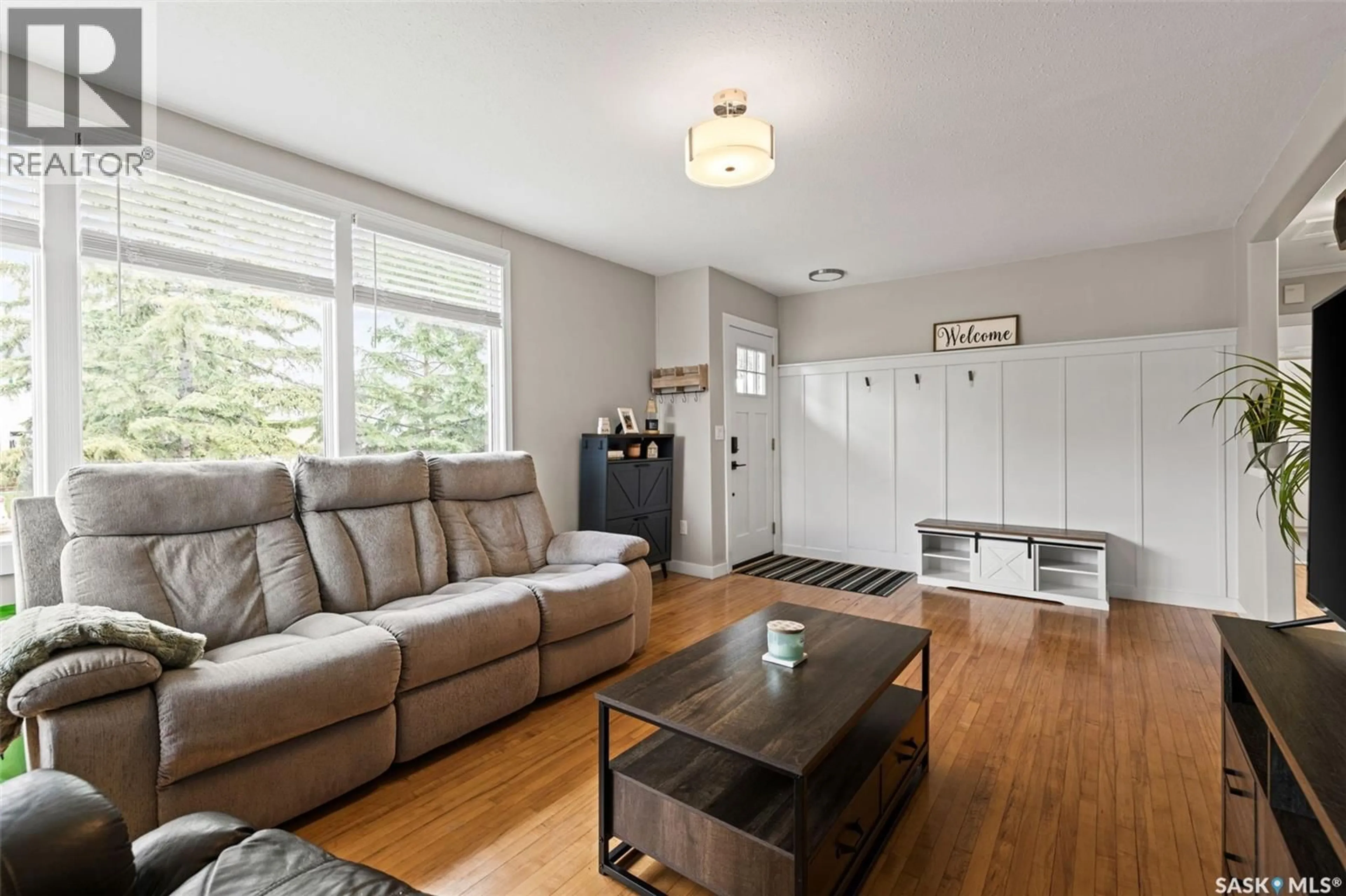 Living room with furniture, wood/laminate floor for 4835 7TH AVENUE, Regina Saskatchewan S4T0R8