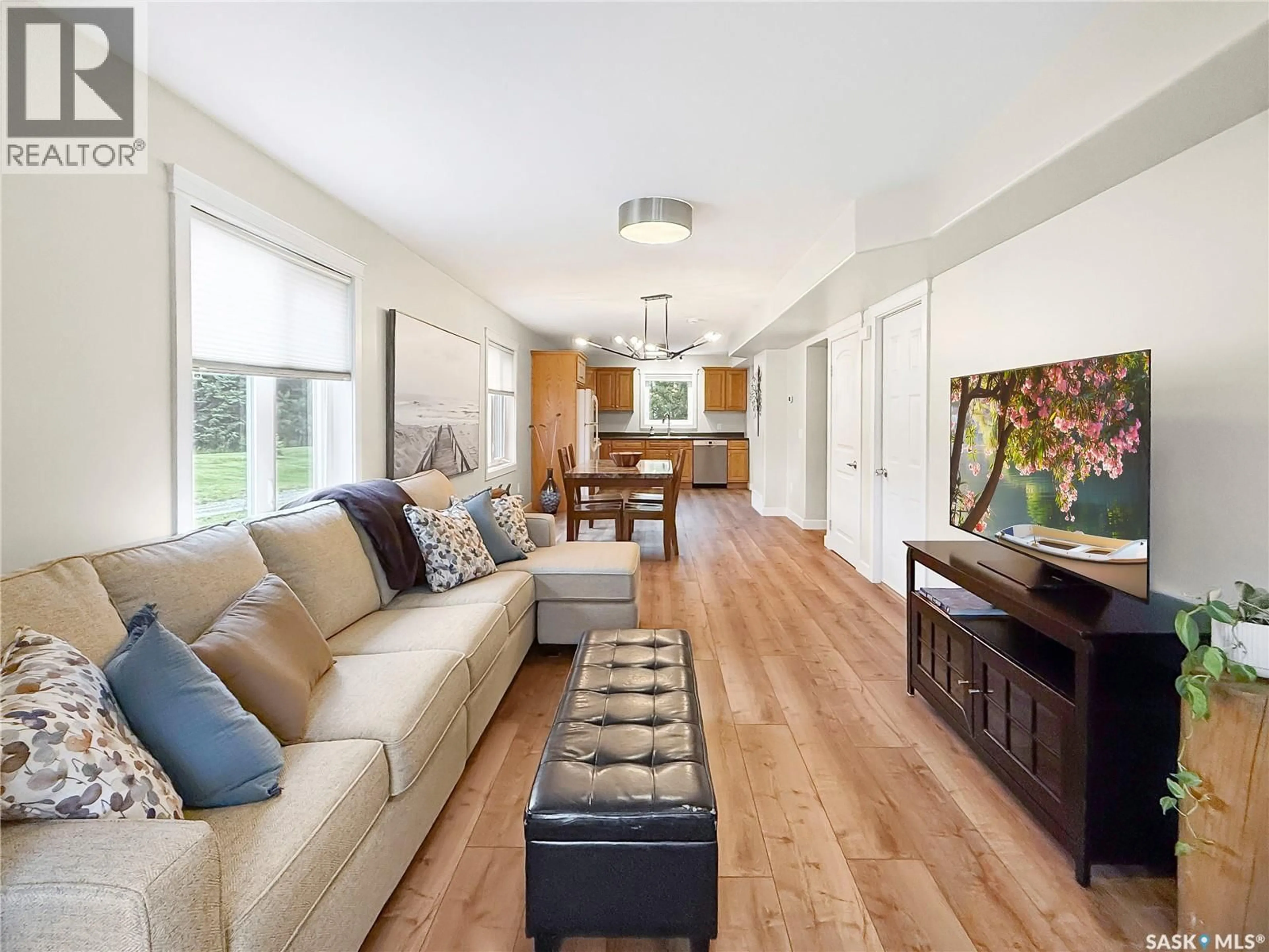Living room with furniture, wood/laminate floor for 50 RUMBERGER ROAD, Candle Lake Saskatchewan S0J3E0
