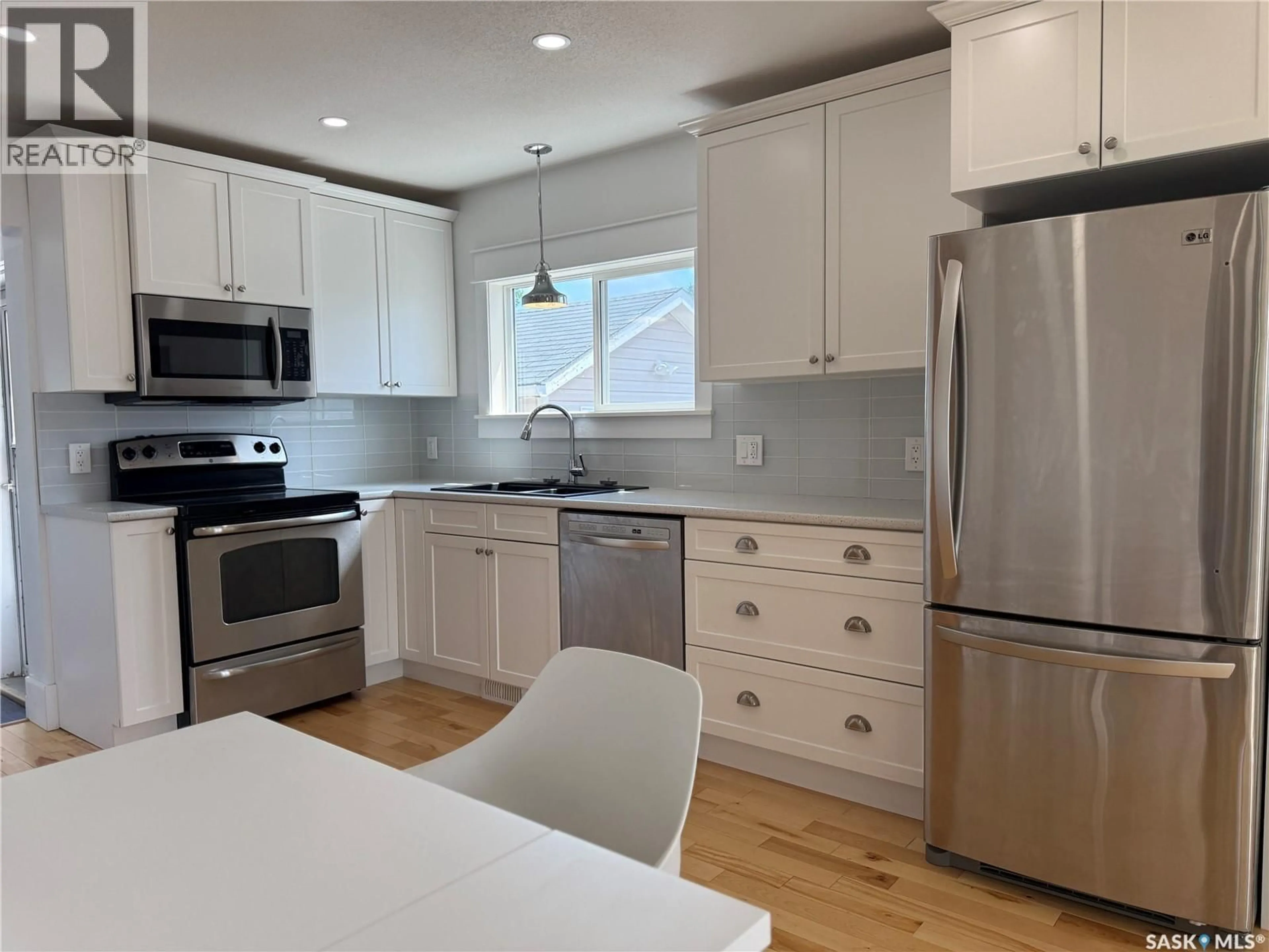 Open concept kitchen, wood/laminate floor for 390 ALBERTA STREET, Melville Saskatchewan S0A2P0