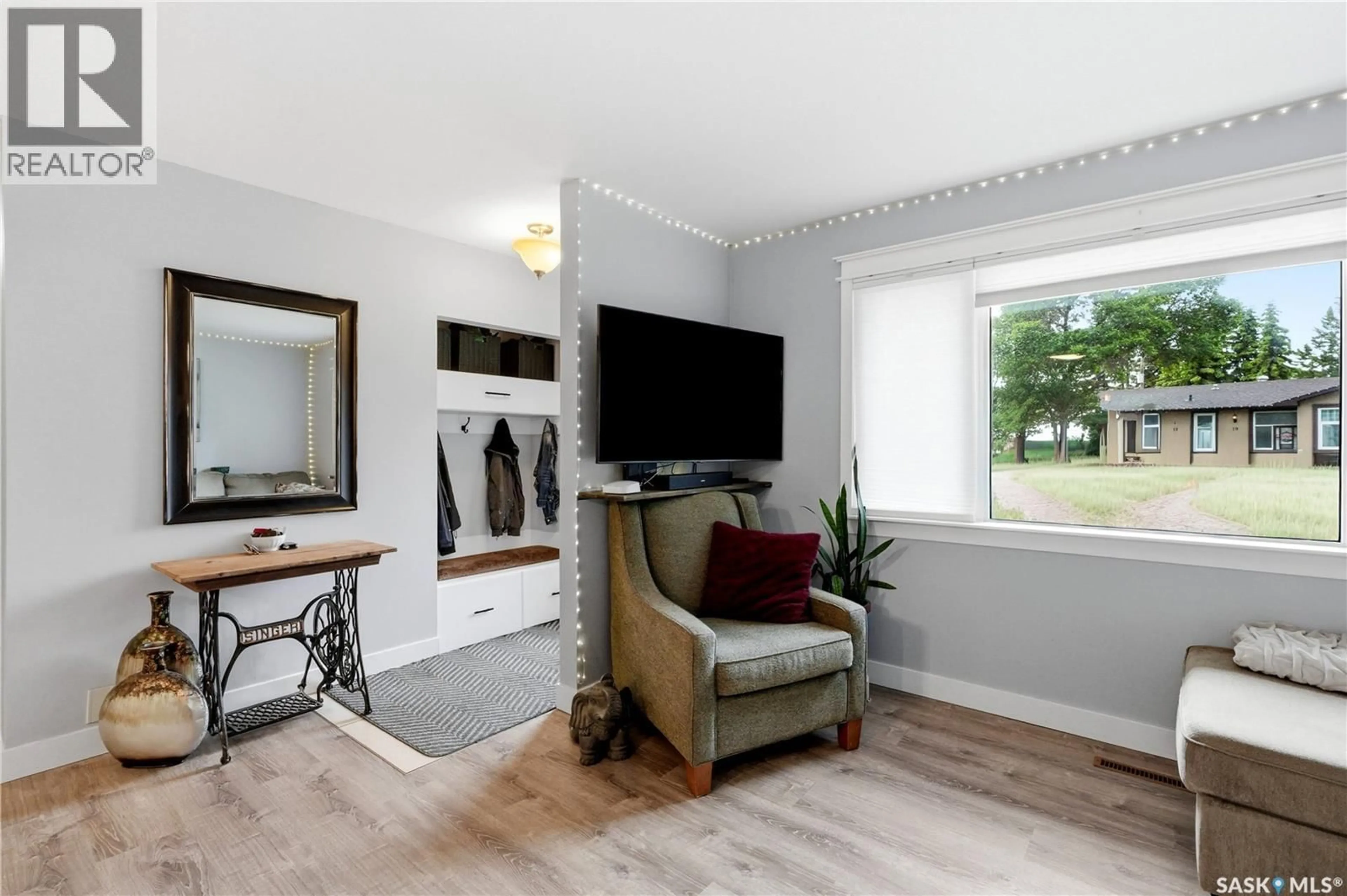 Living room with furniture, wood/laminate floor for 14 STEWART AVENUE, Saskatoon Saskatchewan S7L3S6