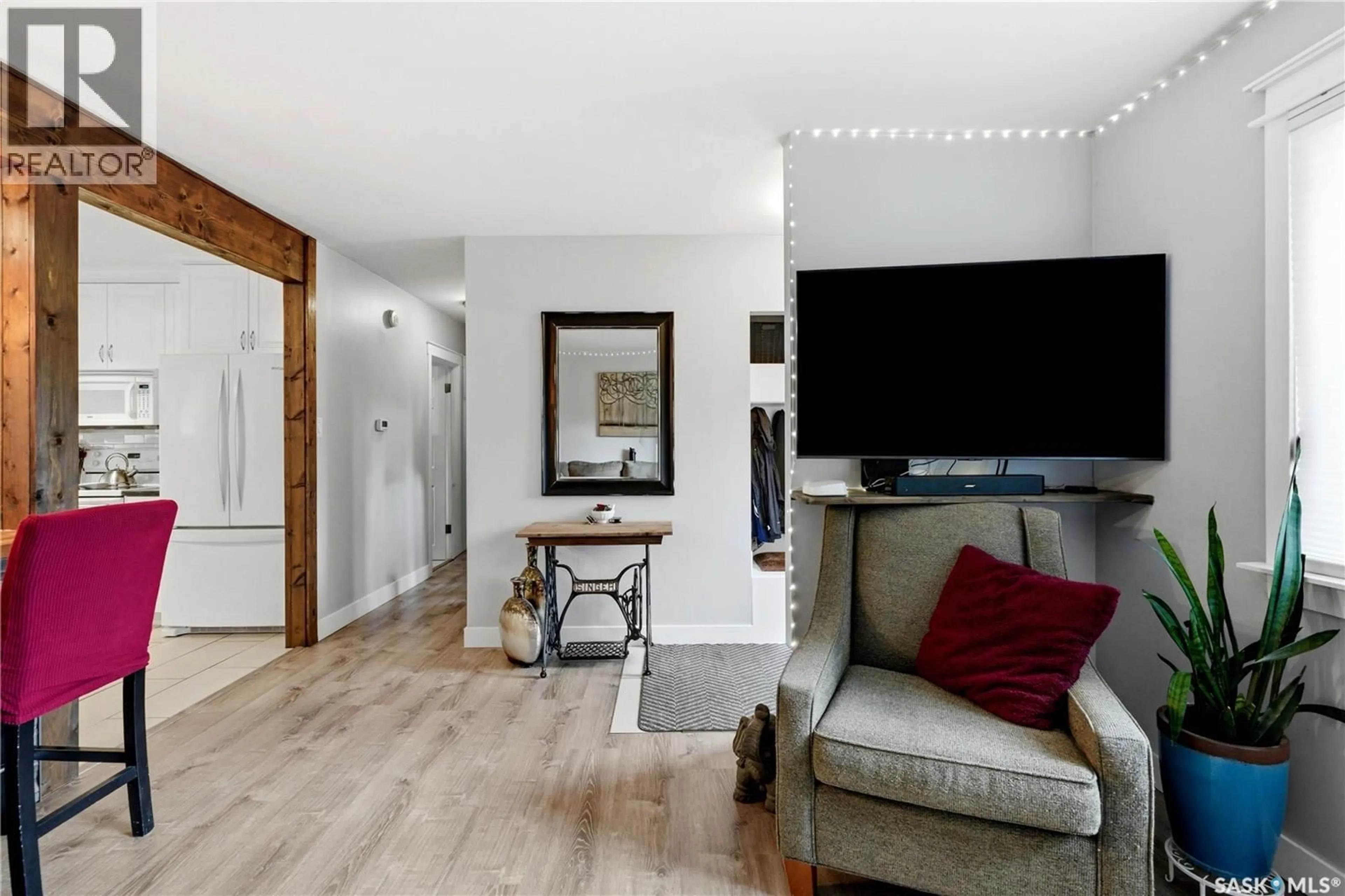 Living room with furniture, wood/laminate floor for 14 STEWART AVENUE, Saskatoon Saskatchewan S7L3S6