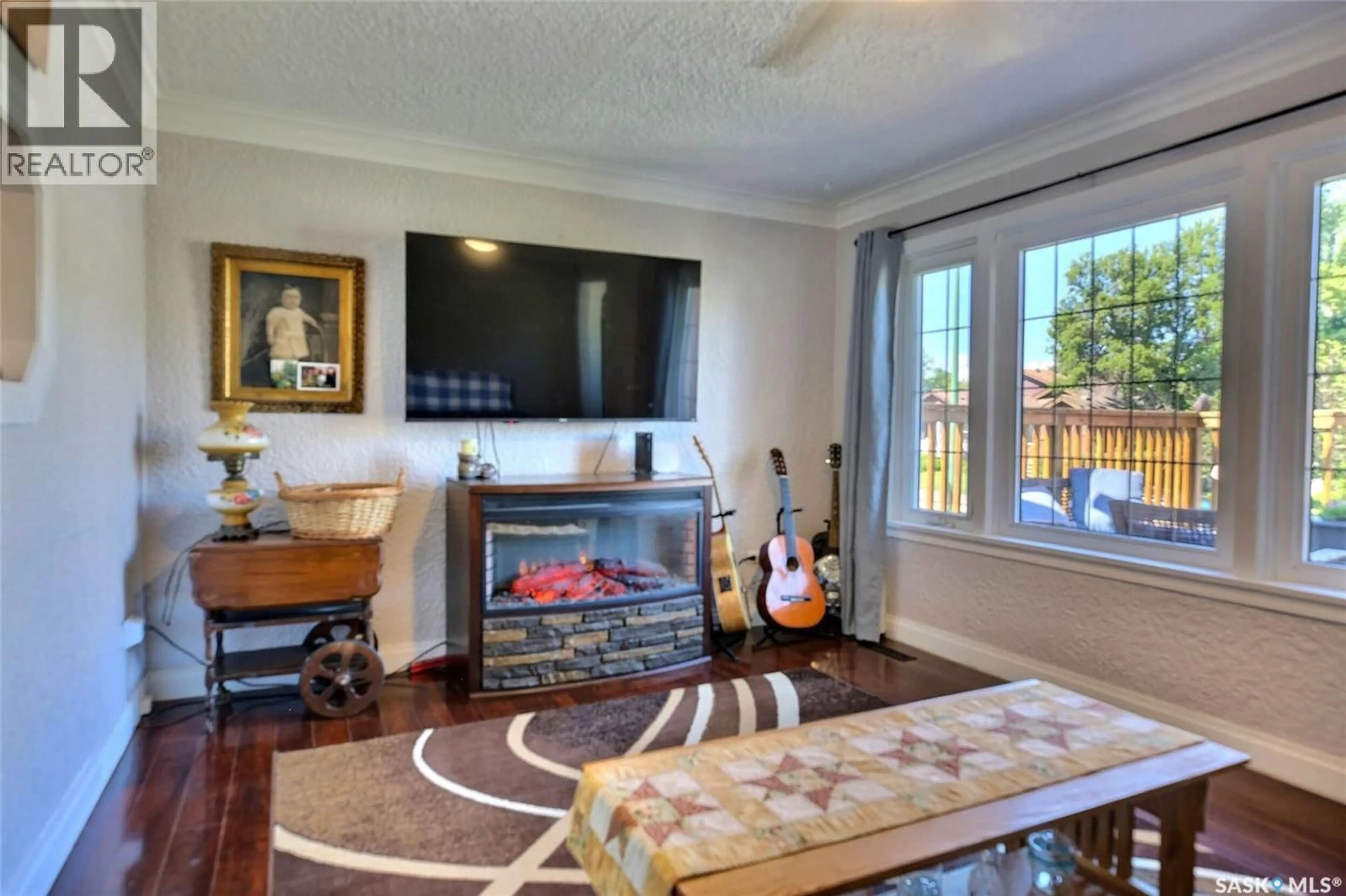 Living room with furniture, wood/laminate floor for 2241 QUEEN STREET, Regina Saskatchewan S4T4C6