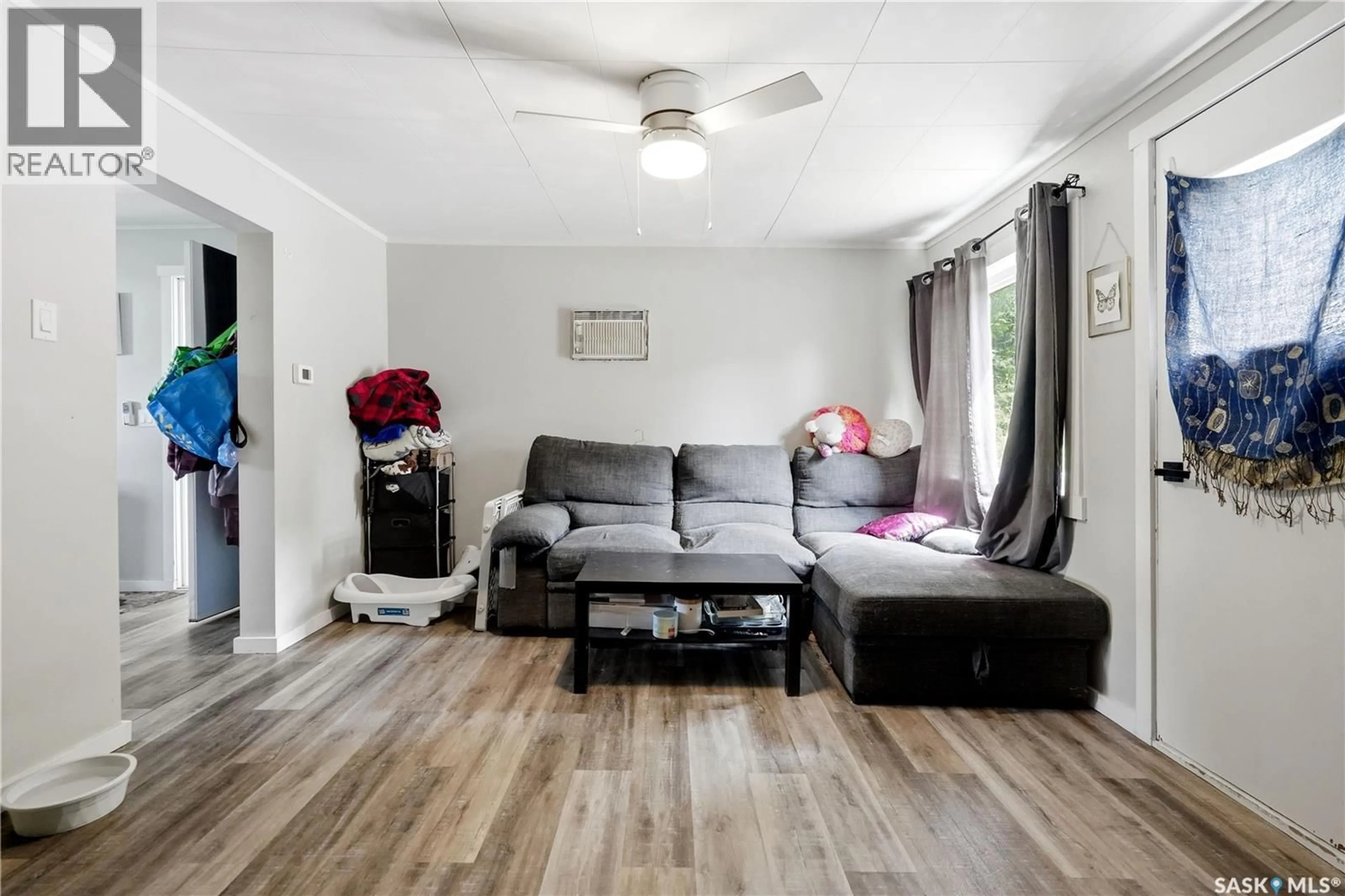 Living room with furniture, wood/laminate floor for 916 IROQUOIS STREET W, Moose Jaw Saskatchewan S6H5B6