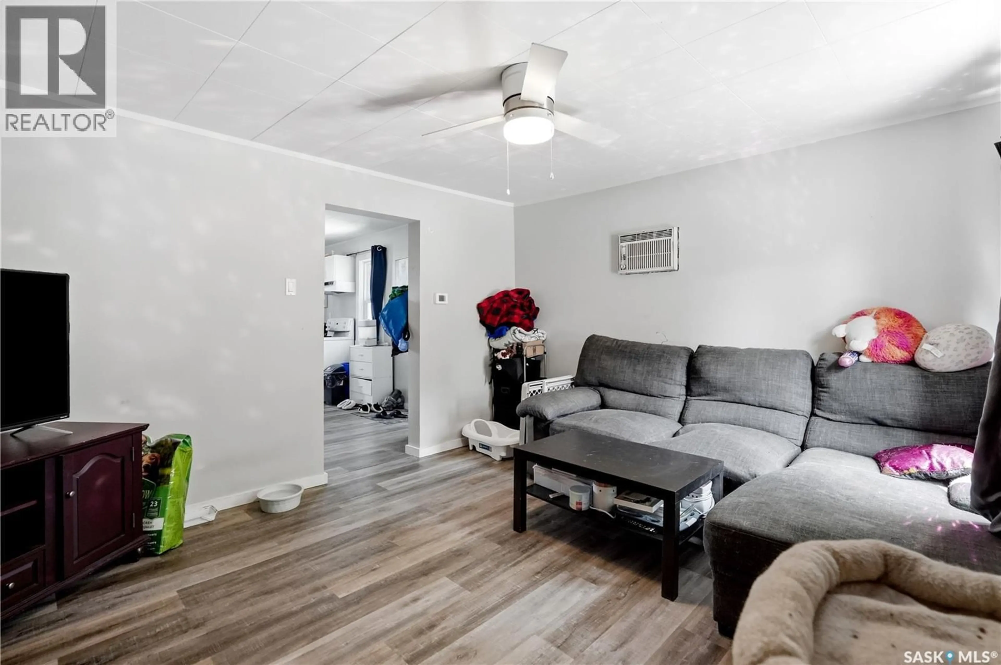 Living room with furniture, wood/laminate floor for 916 IROQUOIS STREET W, Moose Jaw Saskatchewan S6H5B6