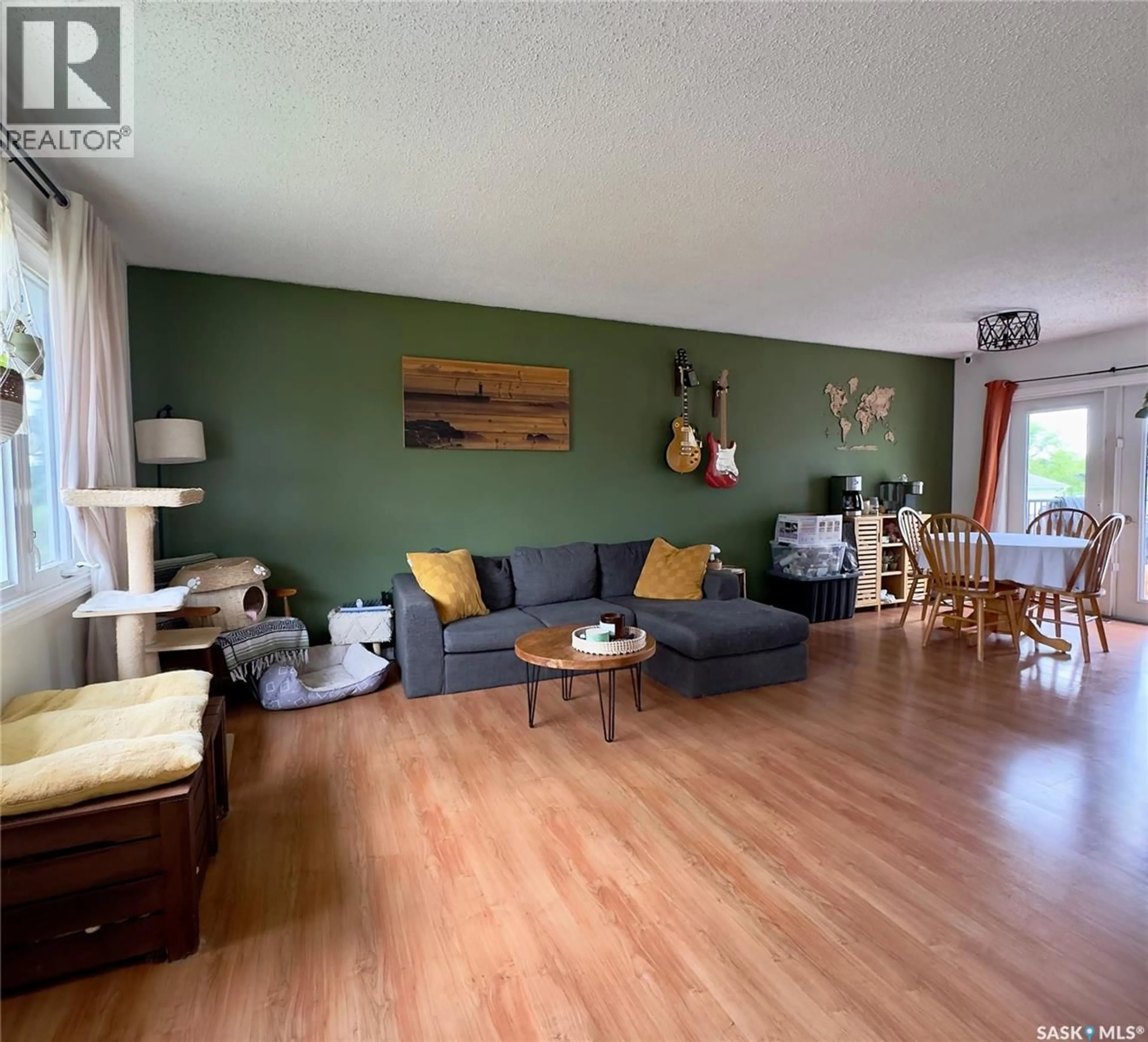 Living room with furniture, wood/laminate floor for 6007 NEUFELD AVENUE, Waldheim Saskatchewan S0K4R0