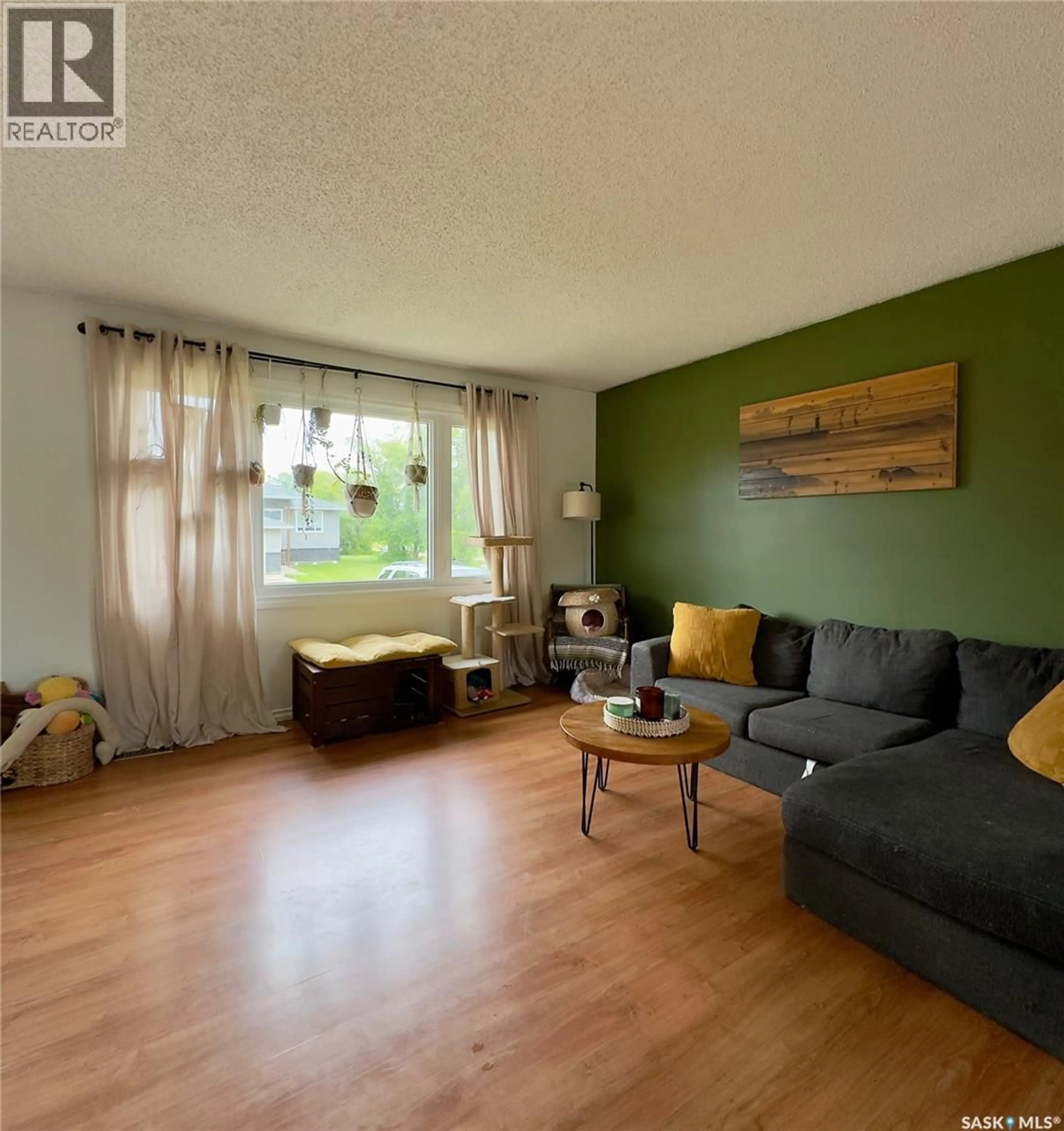 Living room with furniture, wood/laminate floor for 6007 NEUFELD AVENUE, Waldheim Saskatchewan S0K4R0