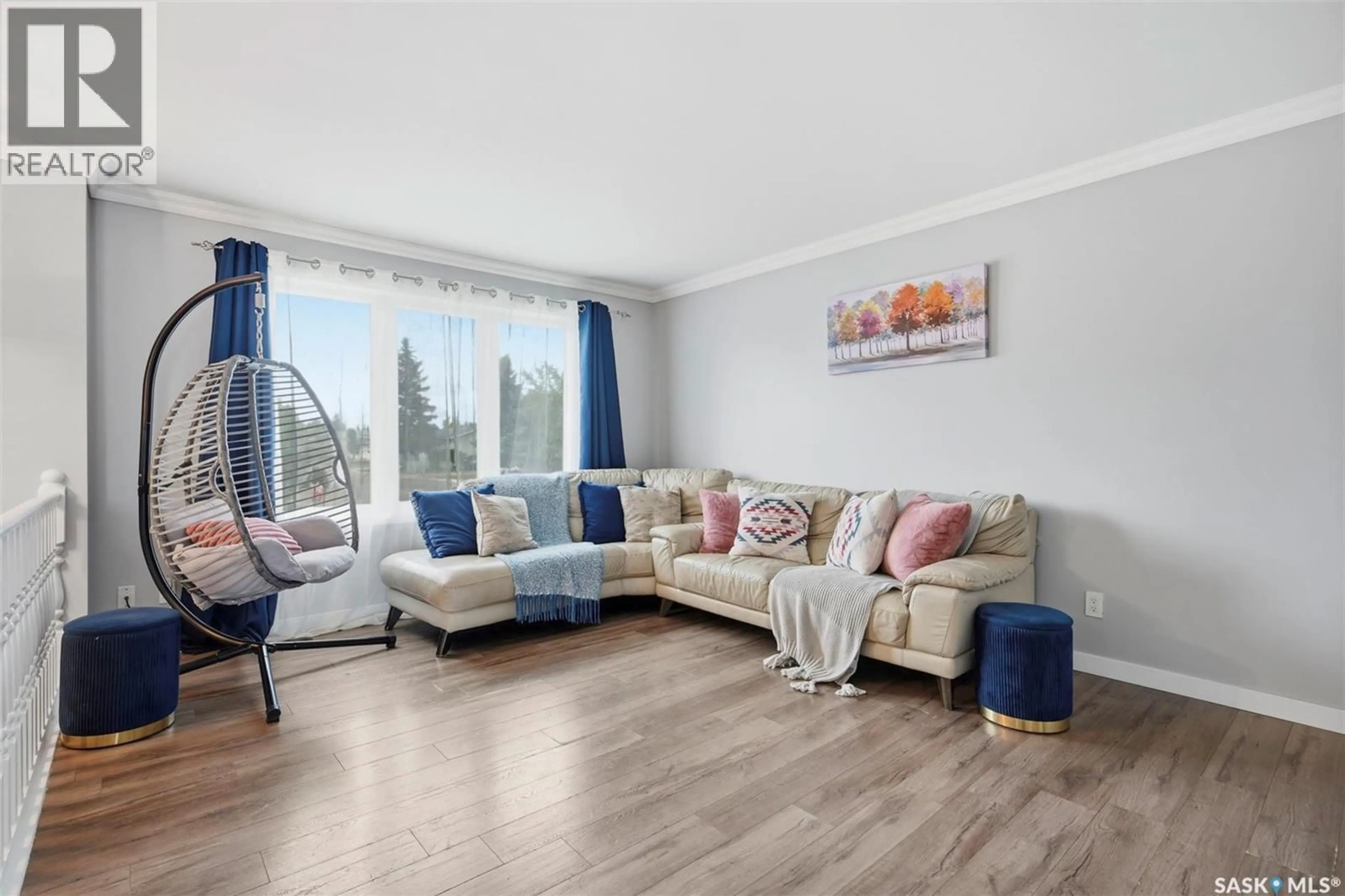 Living room with furniture, wood/laminate floor for 103 NORDSTRUM ROAD, Saskatoon Saskatchewan S7K6P9