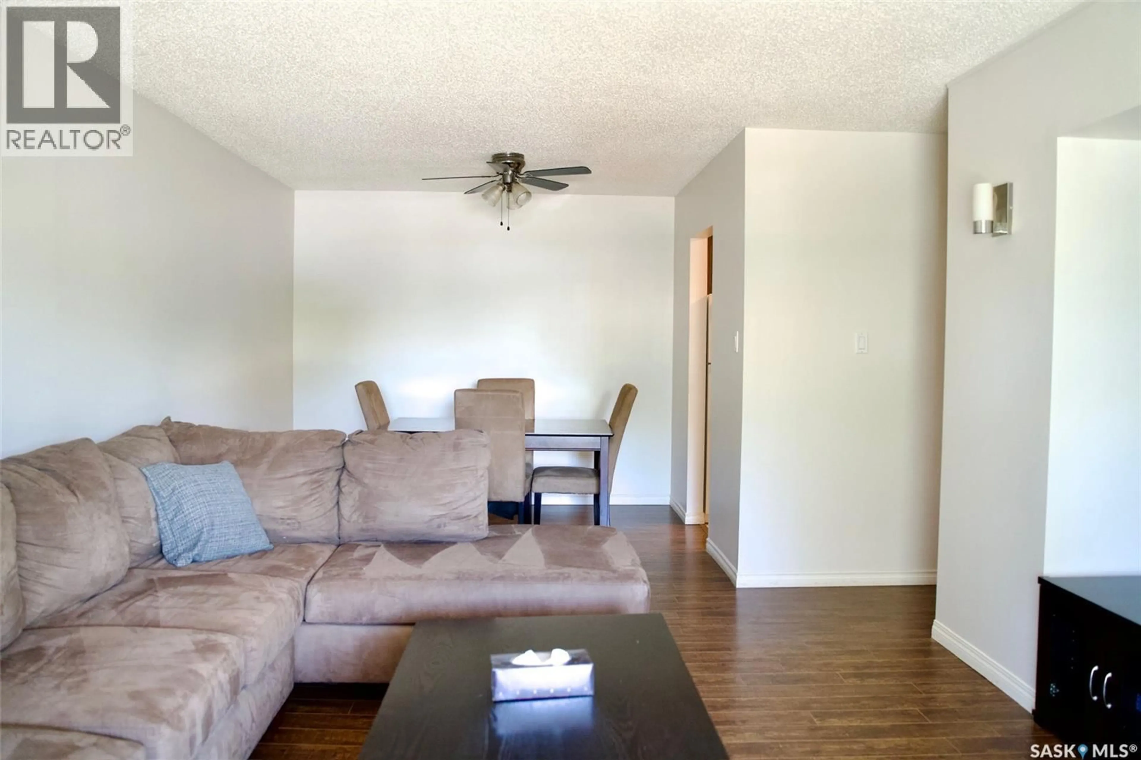 Living room with furniture, wood/laminate floor for 58B NOLLET AVENUE, Regina Saskatchewan S4T7P9