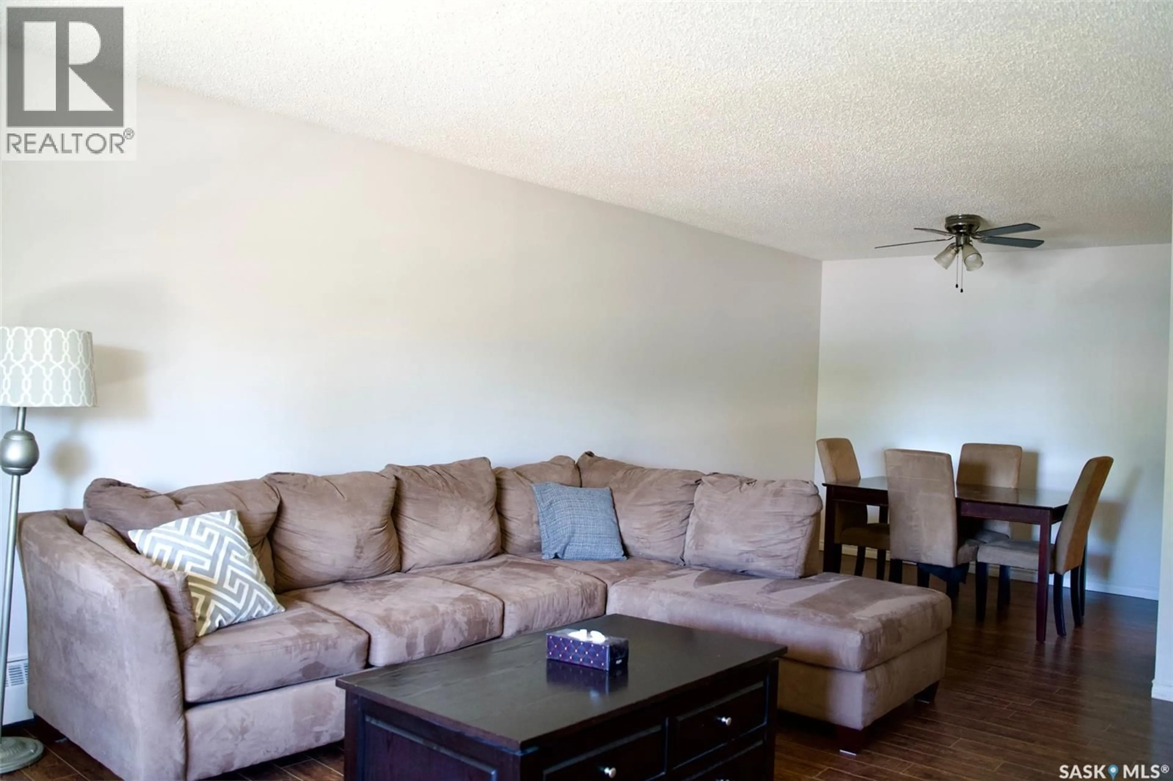 Living room with furniture, wood/laminate floor for 58B NOLLET AVENUE, Regina Saskatchewan S4T7P9