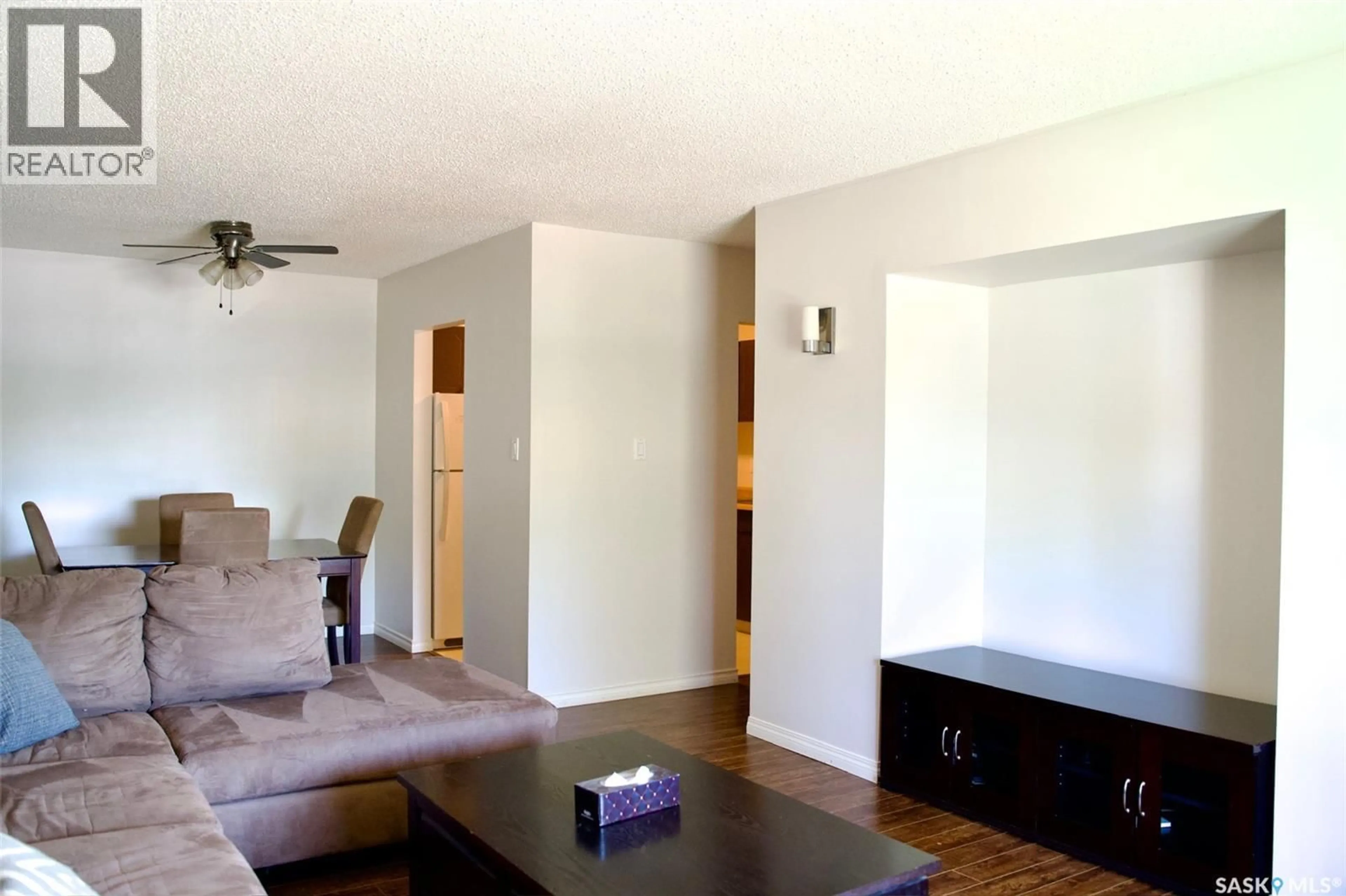 Living room with furniture, wood/laminate floor for 58B NOLLET AVENUE, Regina Saskatchewan S4T7P9