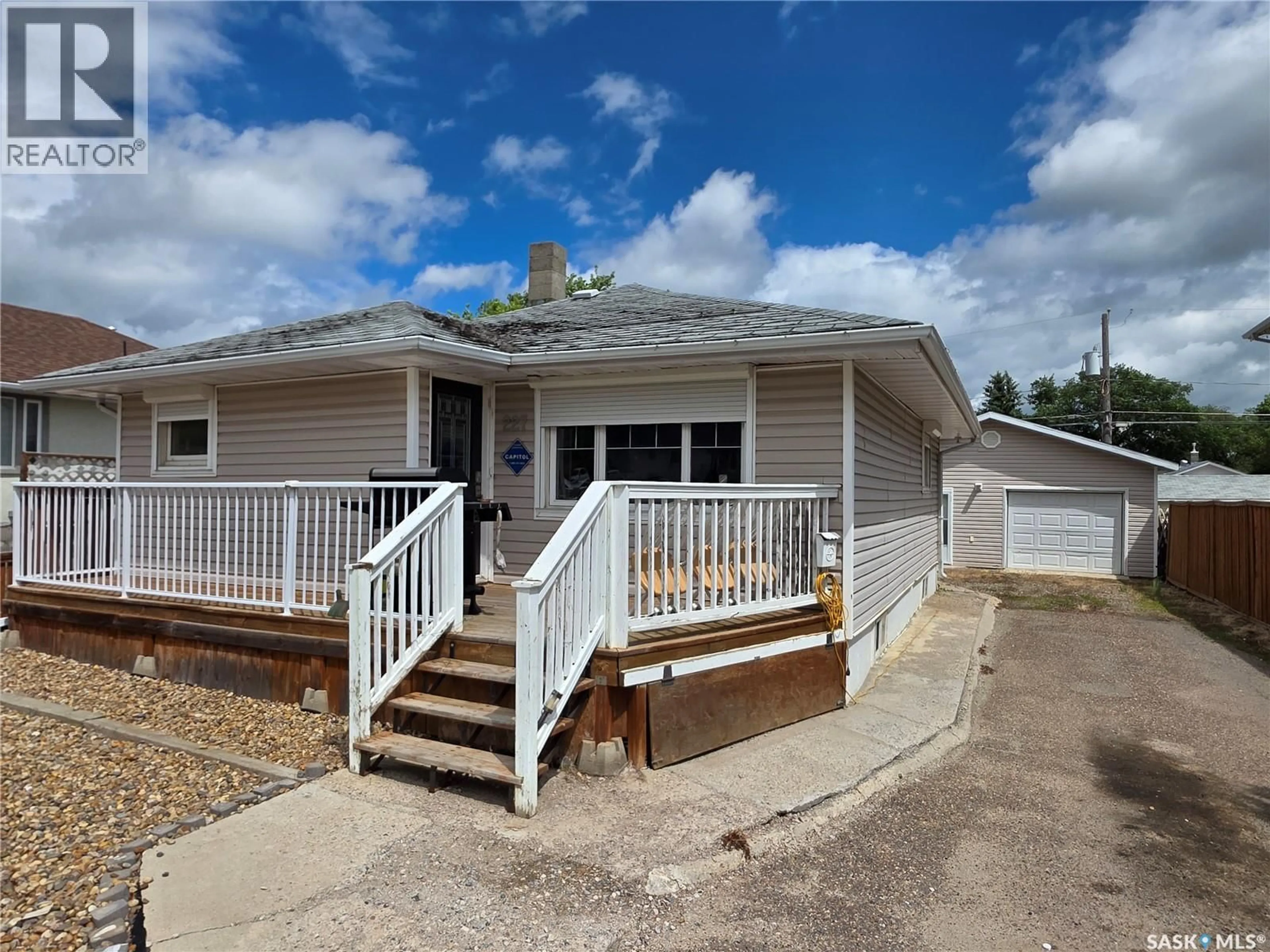 Home with vinyl exterior material, street for 227 10TH AVENUE, Swift Current Saskatchewan S9H1B4